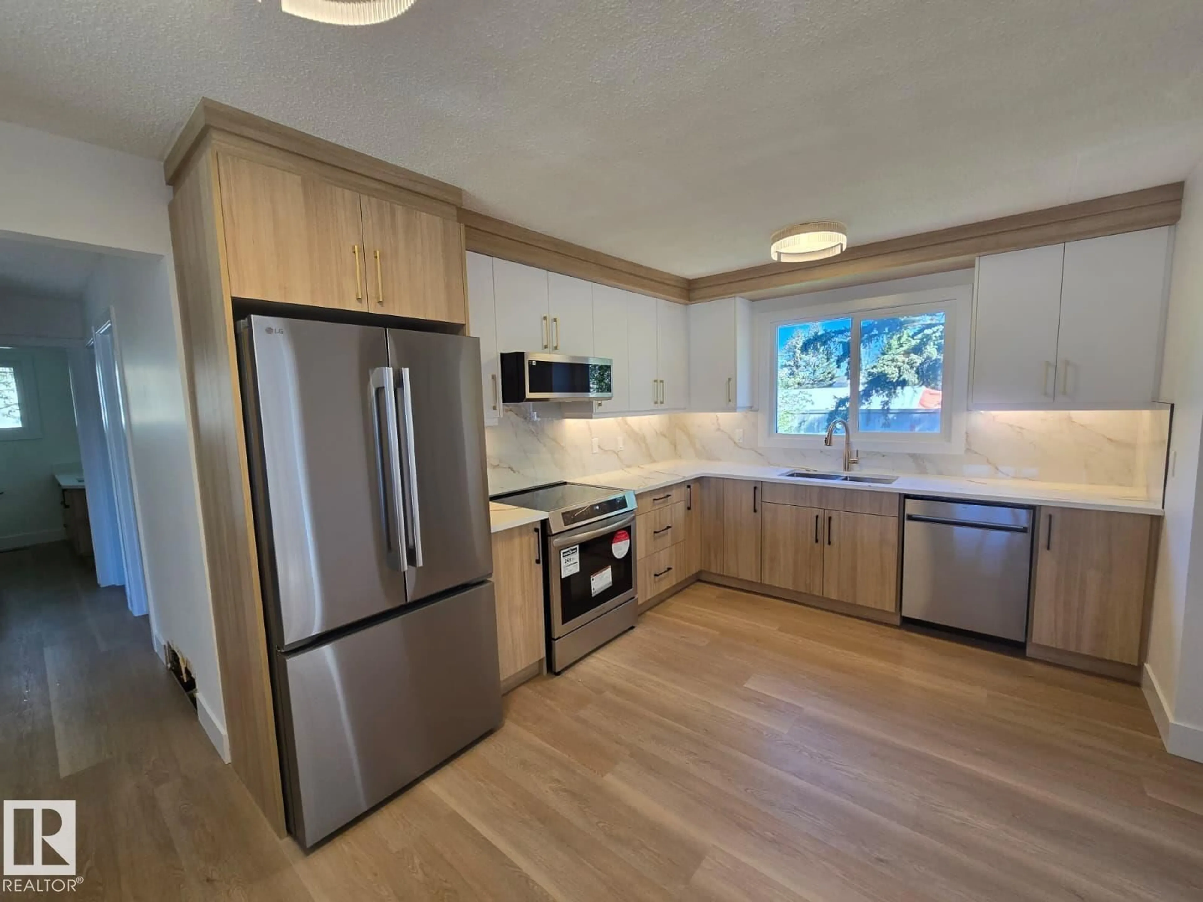 Open concept kitchen, wood/laminate floor for 18526 86A AV, Edmonton Alberta T6T1J6