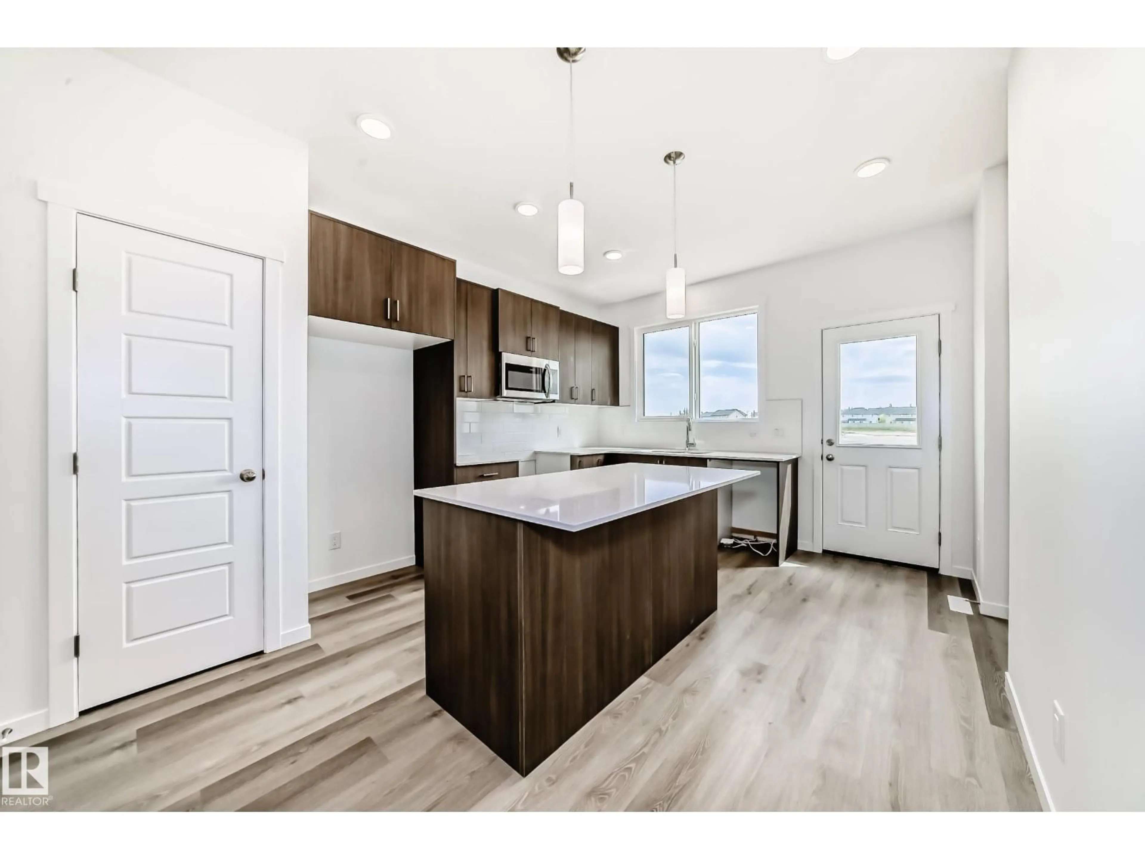 Open concept kitchen, wood/laminate floor for 6407 63 ST, Beaumont Alberta T4X3E2
