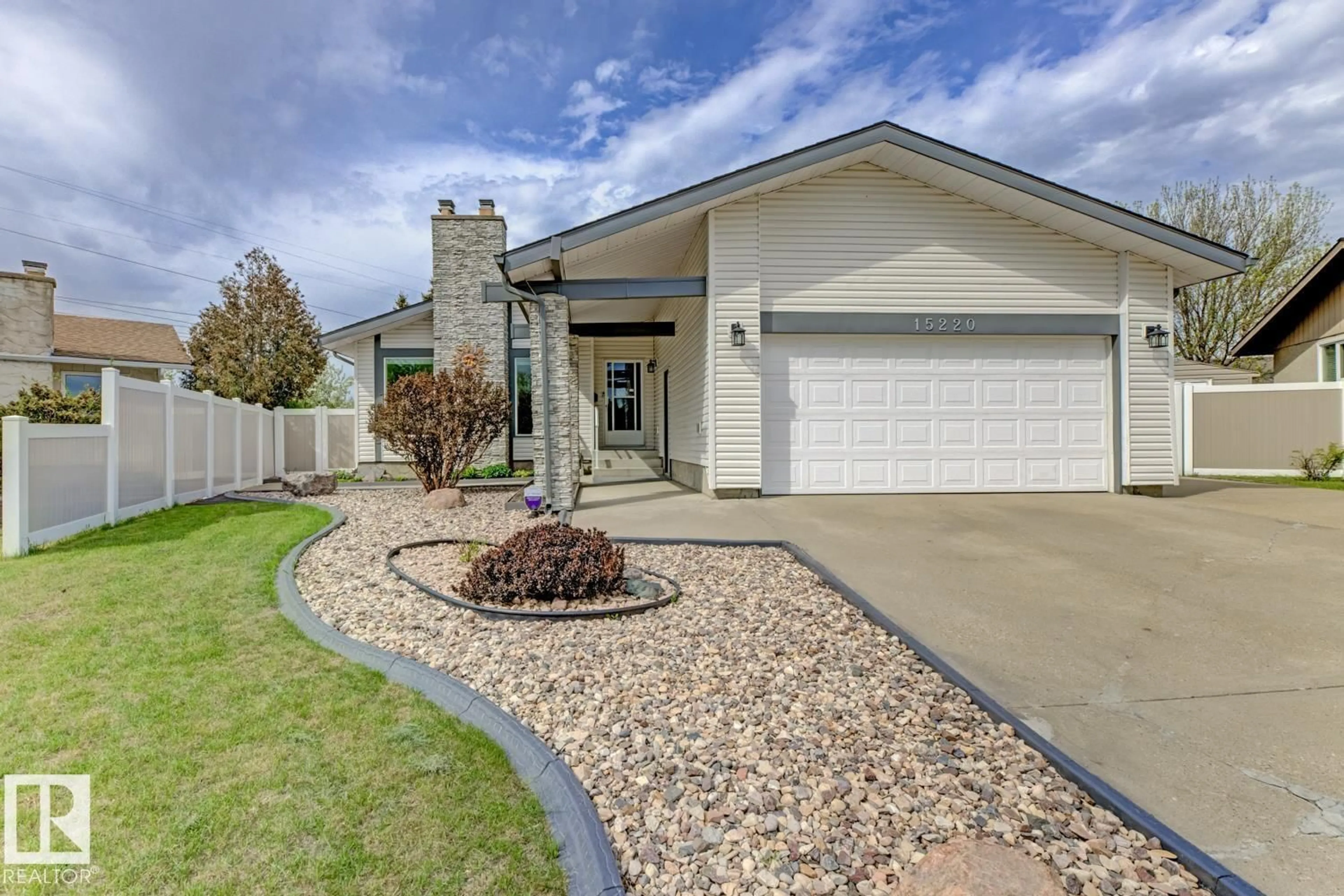 Home with vinyl exterior material, street for 15220 124 ST NW, Edmonton Alberta T5X1Z3