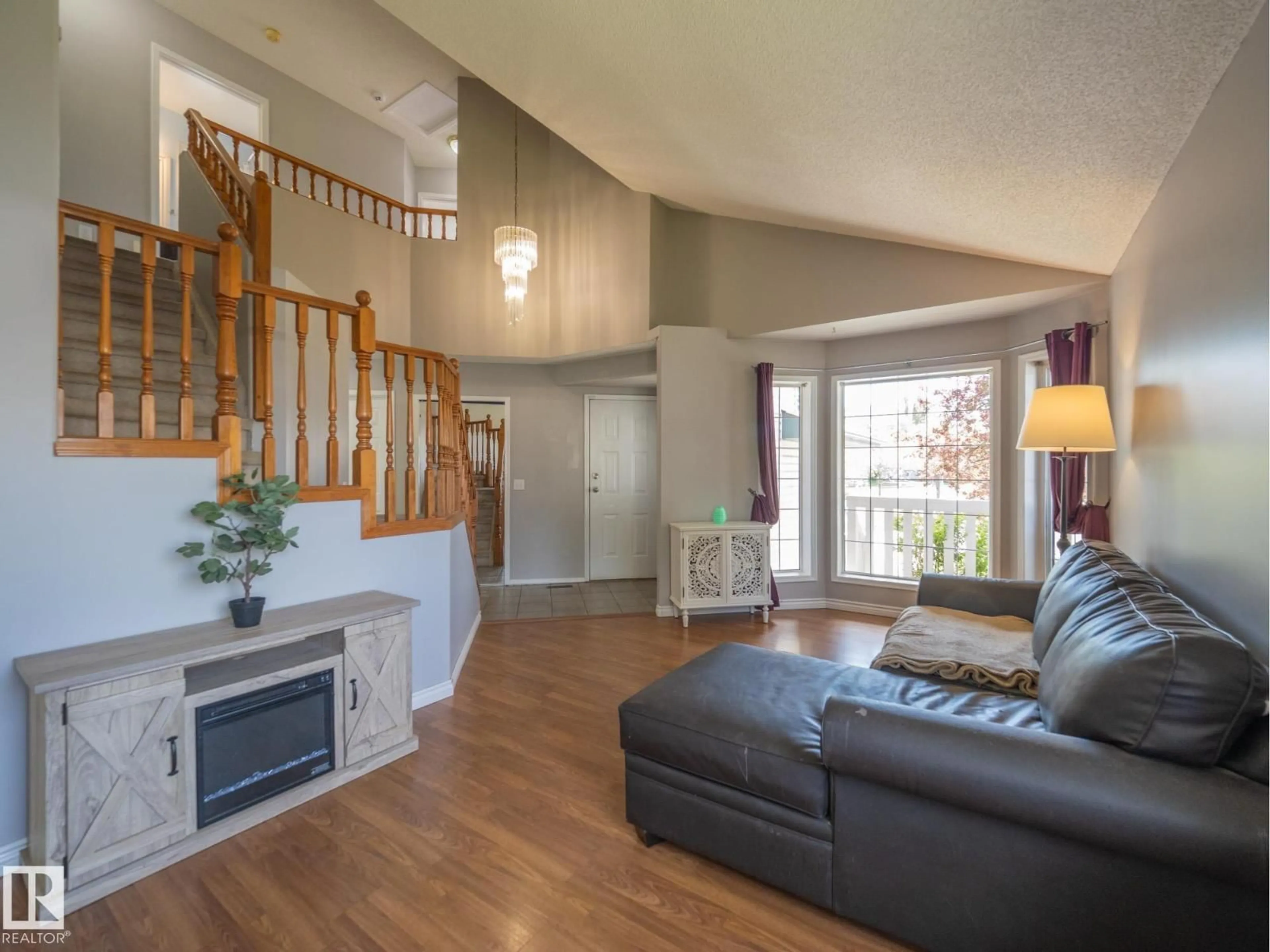 Living room with furniture, wood/laminate floor for 129 REGENCY DR, Sherwood Park Alberta T8A5R9