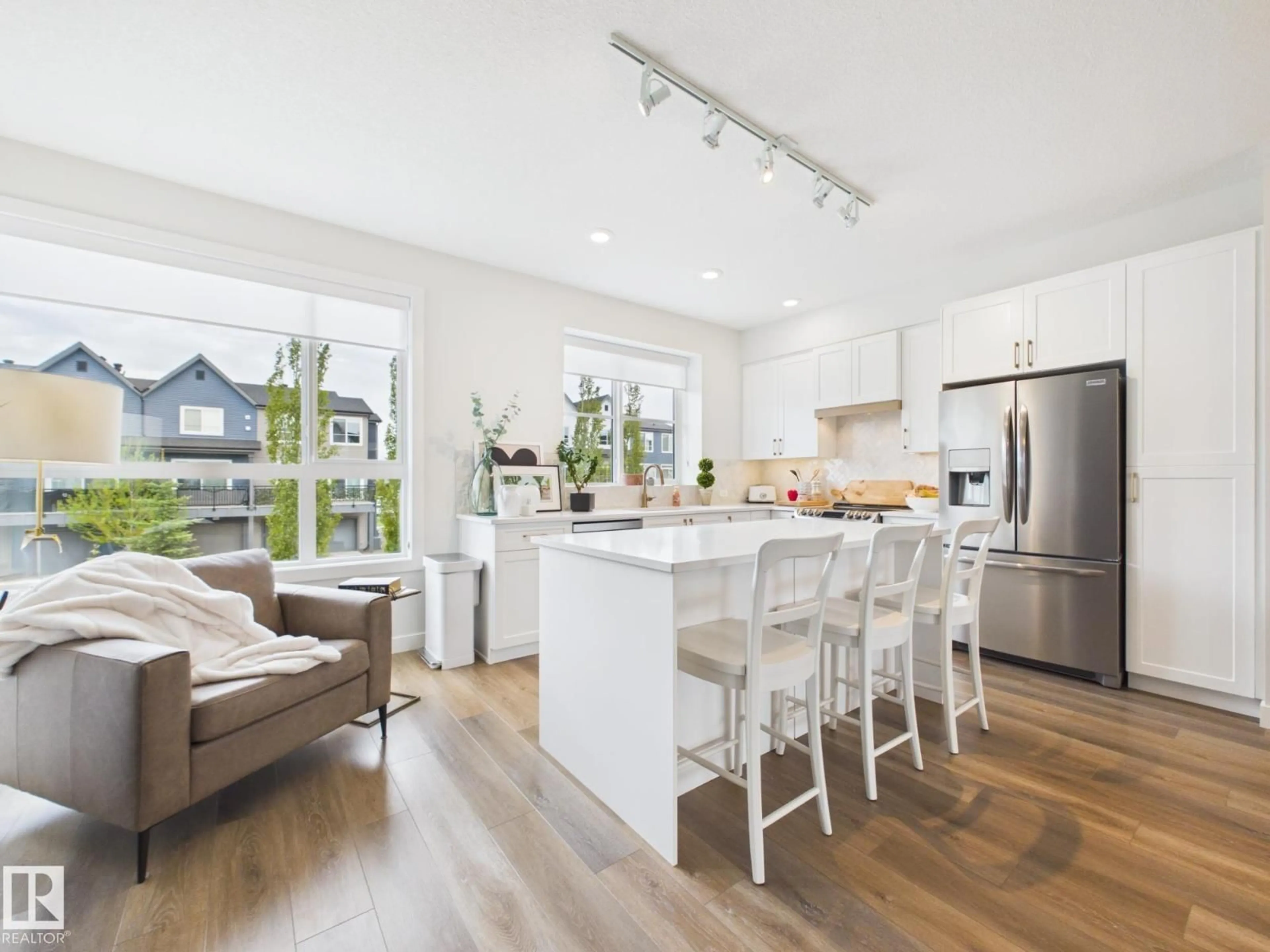 Open concept kitchen, wood/laminate floor for 32 100 JENSEN LAKES BV, St. Albert Alberta T8N7T9