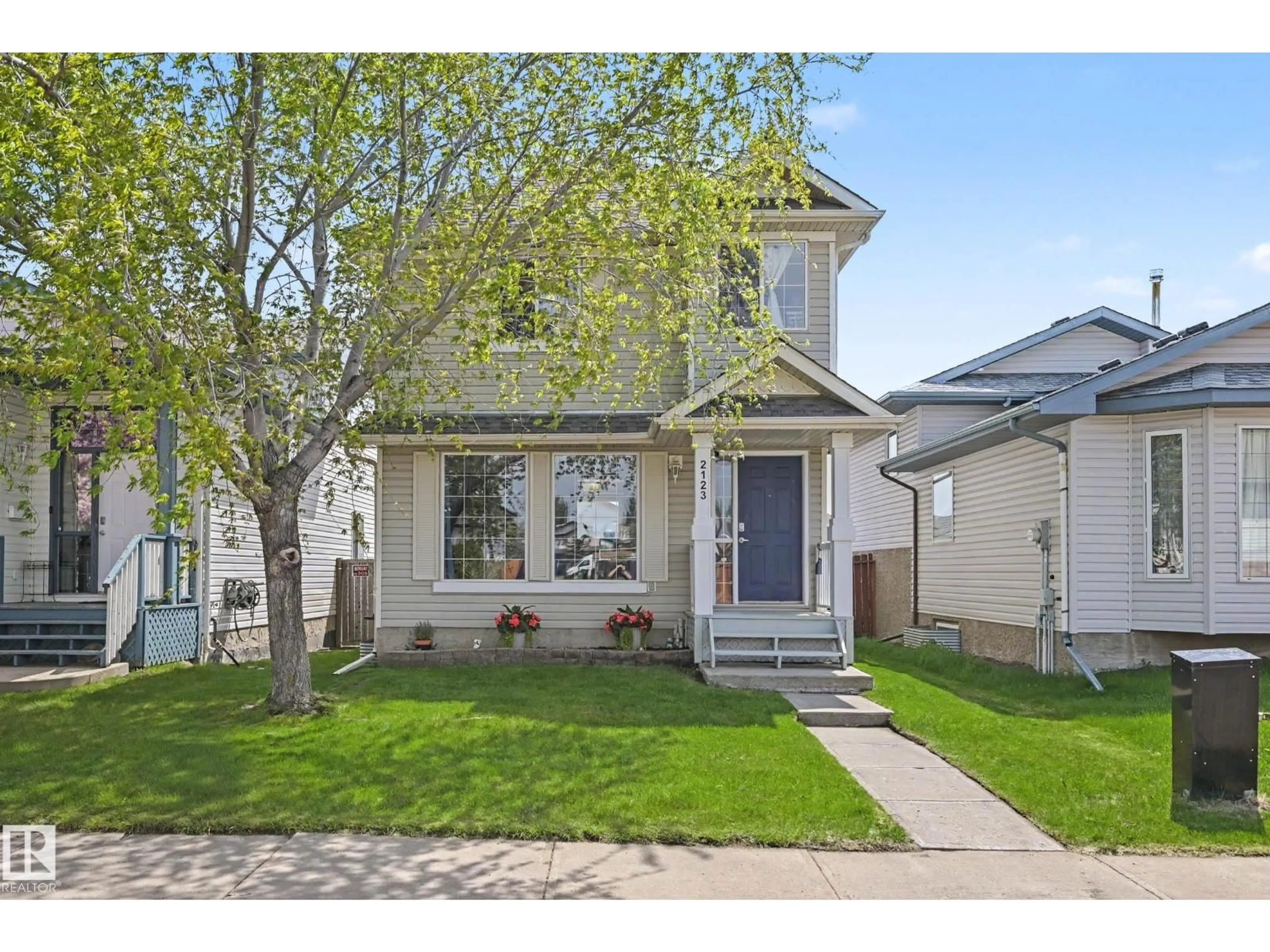 Home with vinyl exterior material, street for 2123 36 AV, Edmonton Alberta T6T1S3