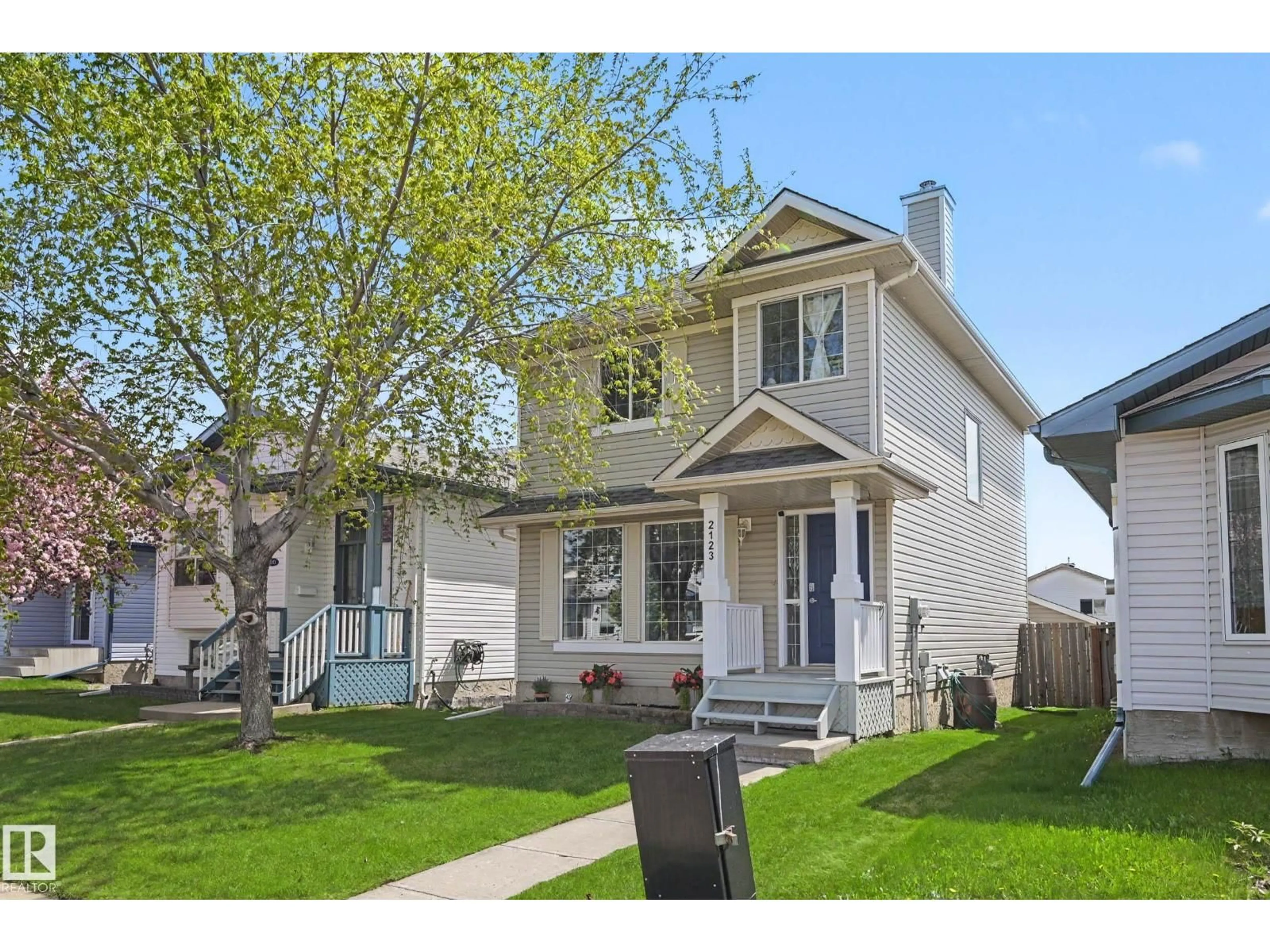 Home with vinyl exterior material, street for 2123 36 AV, Edmonton Alberta T6T1S3