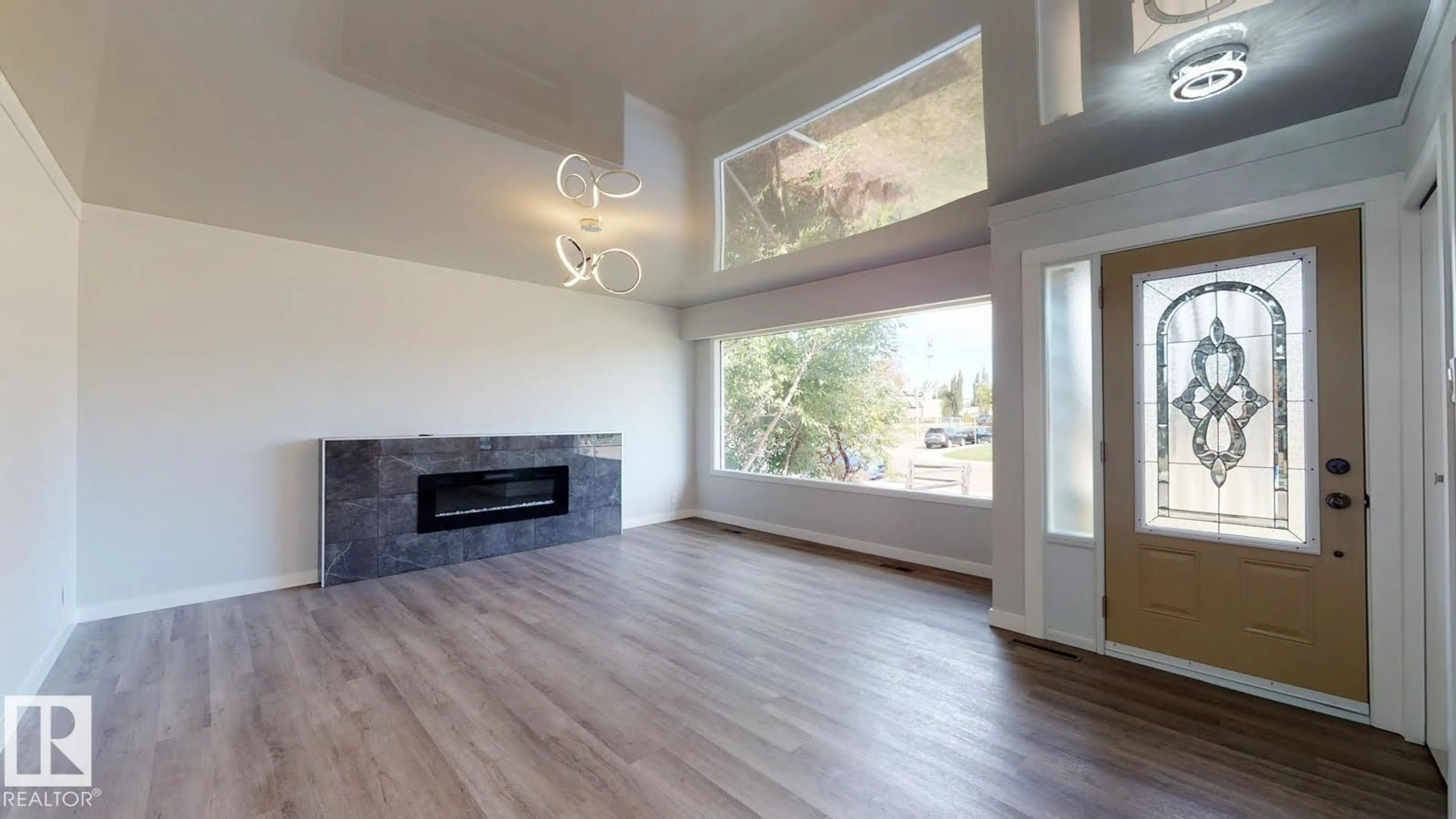 Living room with furniture, wood/laminate floor for 11744 135 ST, Edmonton Alberta T5M1L3