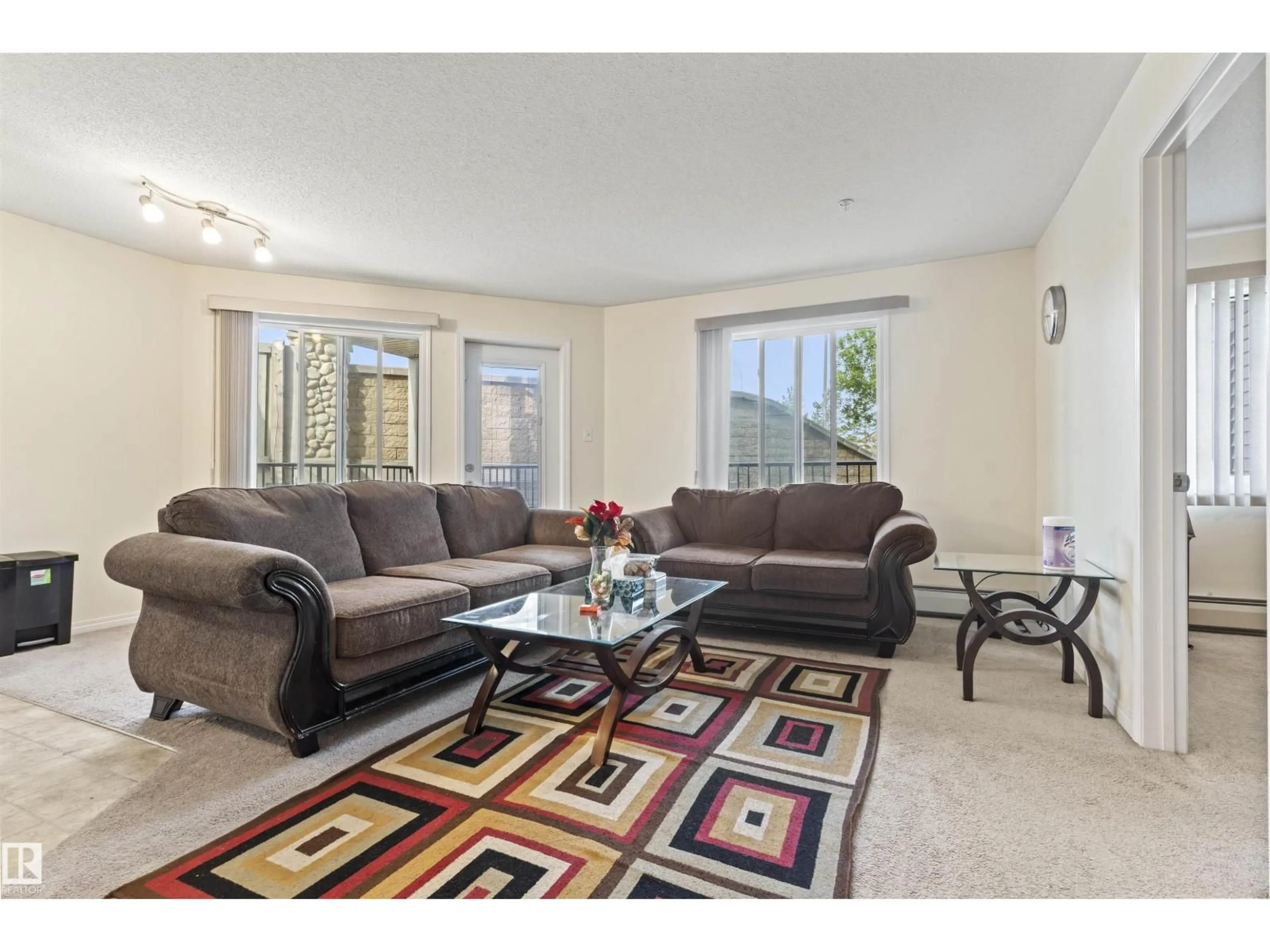 Living room with furniture, carpet floor for 111 - 117 EDWARDS DR, Edmonton Alberta T6X0C4