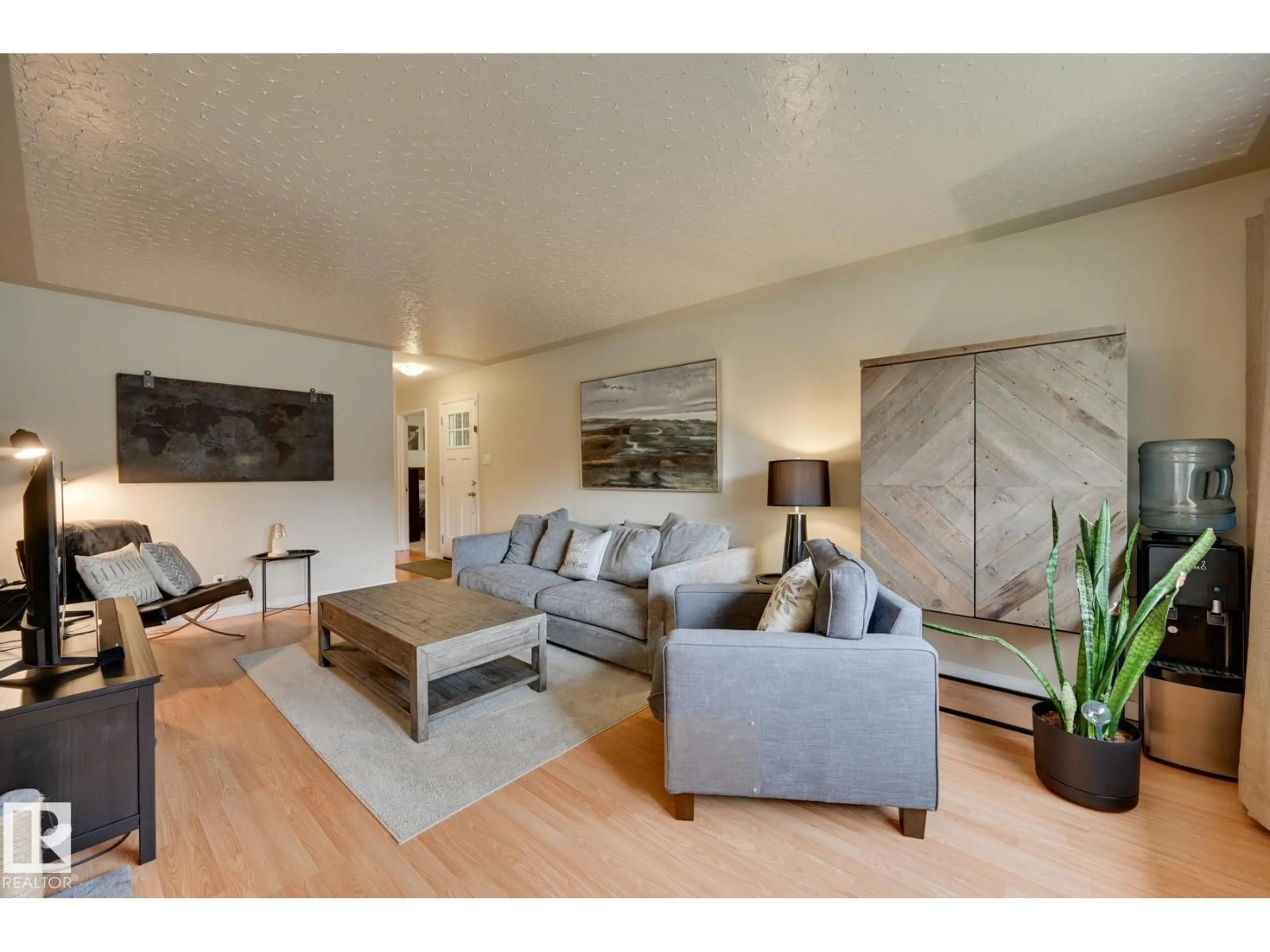 Living room with furniture, wood/laminate floor for 7527 78 AV, Edmonton Alberta T6C0M6
