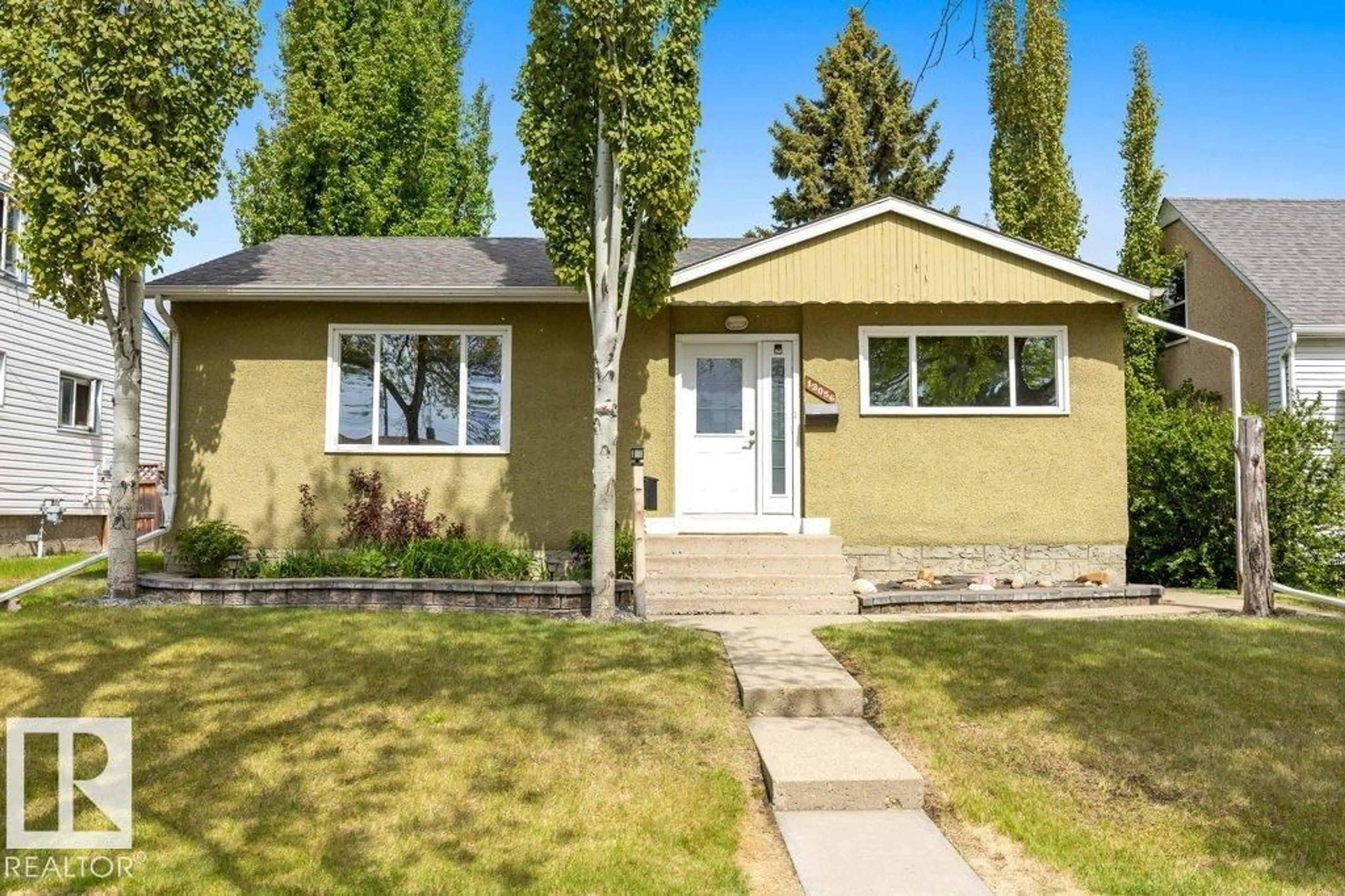 Home with vinyl exterior material, street for 13056 SHERBROOKE AV, Edmonton Alberta T5L4E9