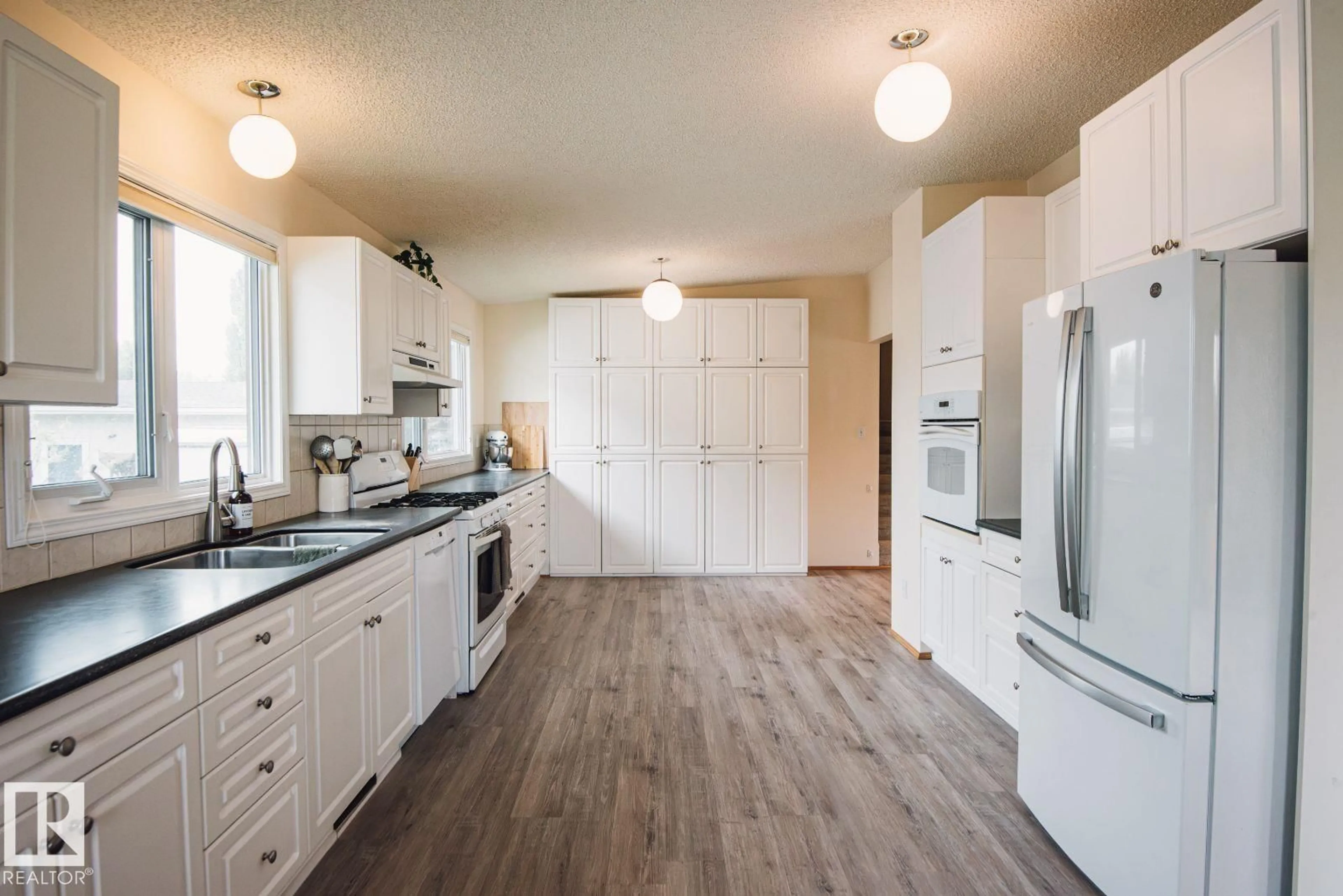 Open concept kitchen, wood/laminate floor for 14916 94 ST, Edmonton Alberta T5E3W6