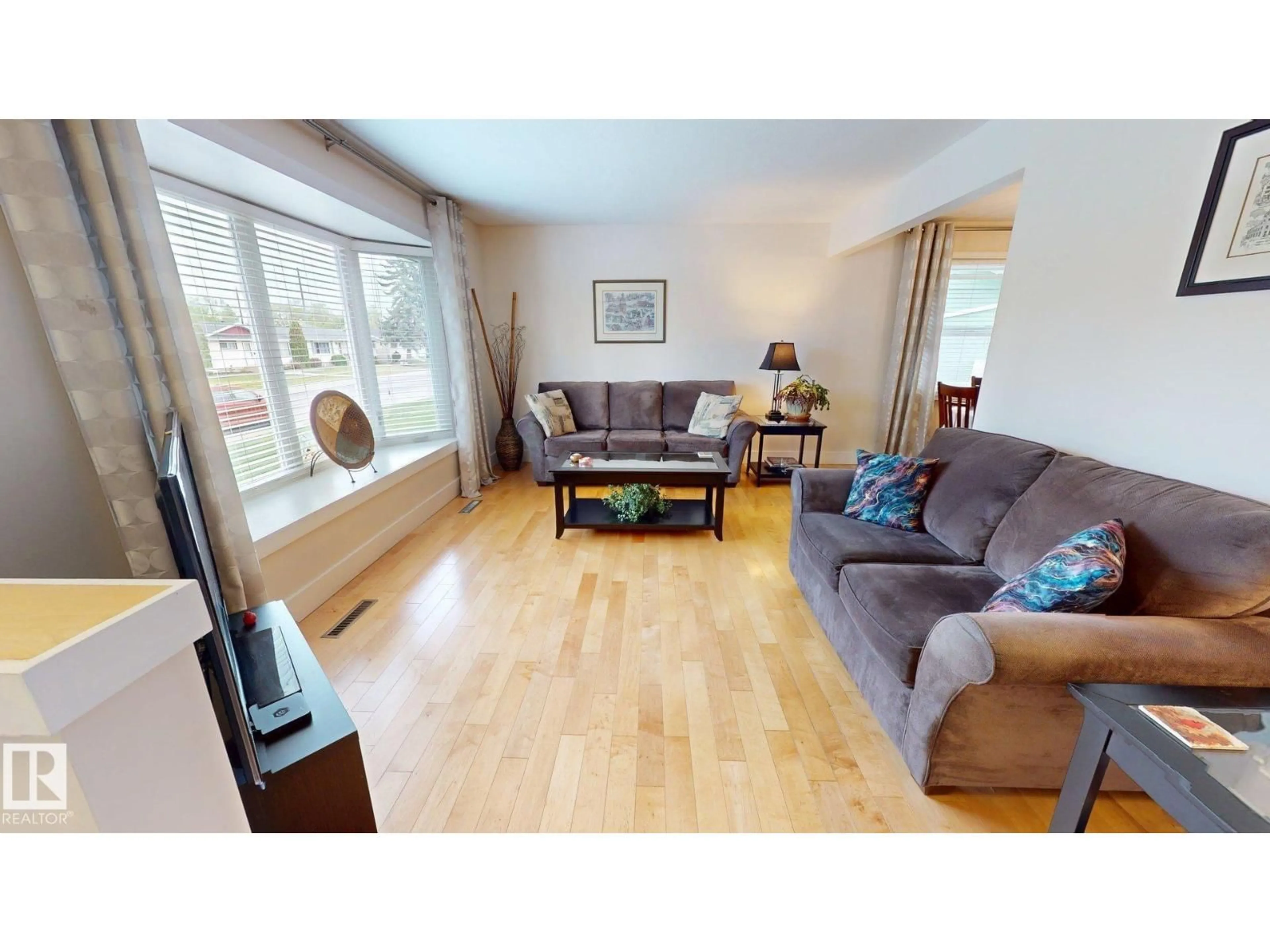 Living room with furniture, wood/laminate floor for 15627 83 AV, Edmonton Alberta T5R3T6