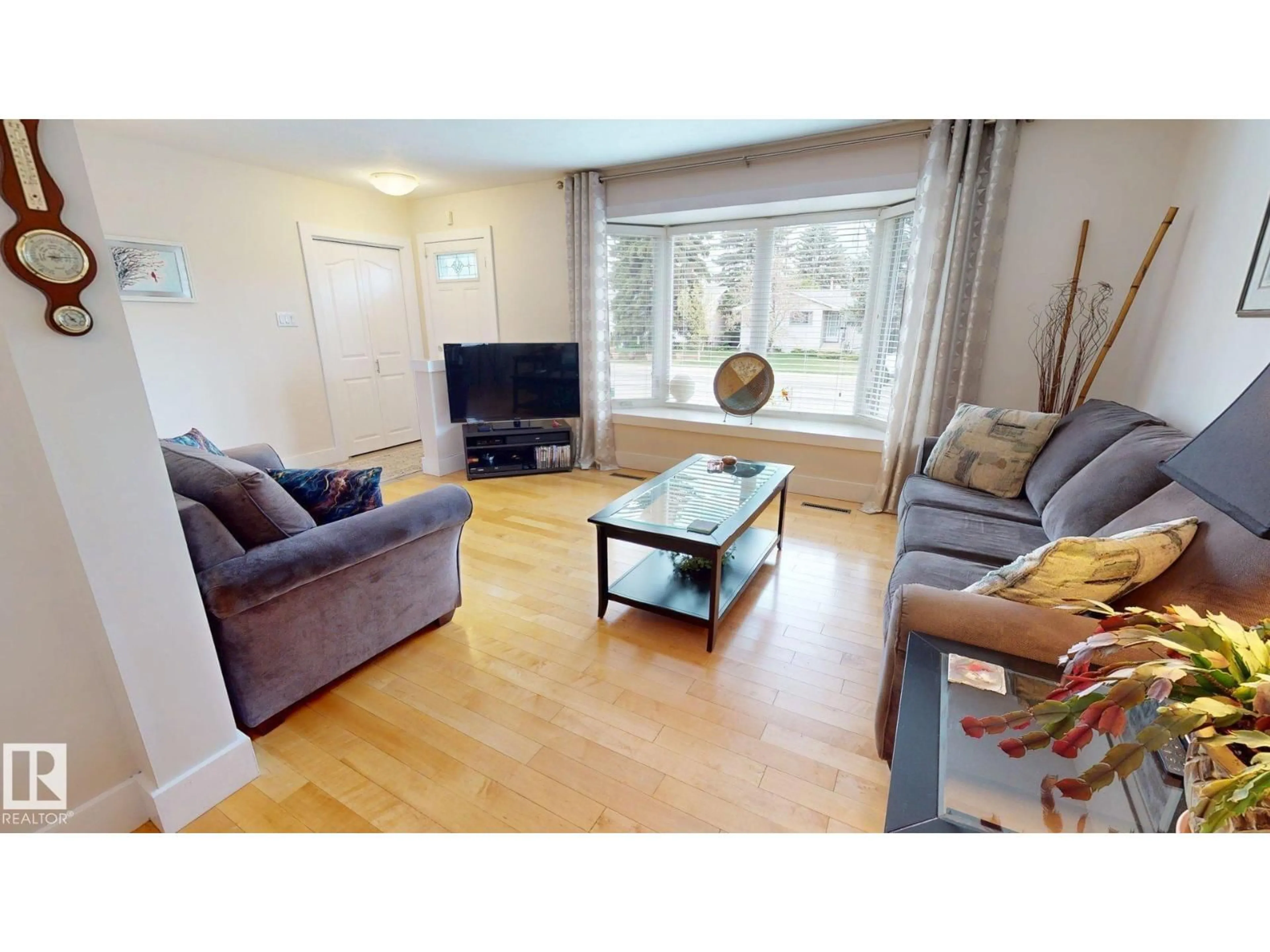 Living room with furniture, wood/laminate floor for 15627 83 AV, Edmonton Alberta T5R3T6