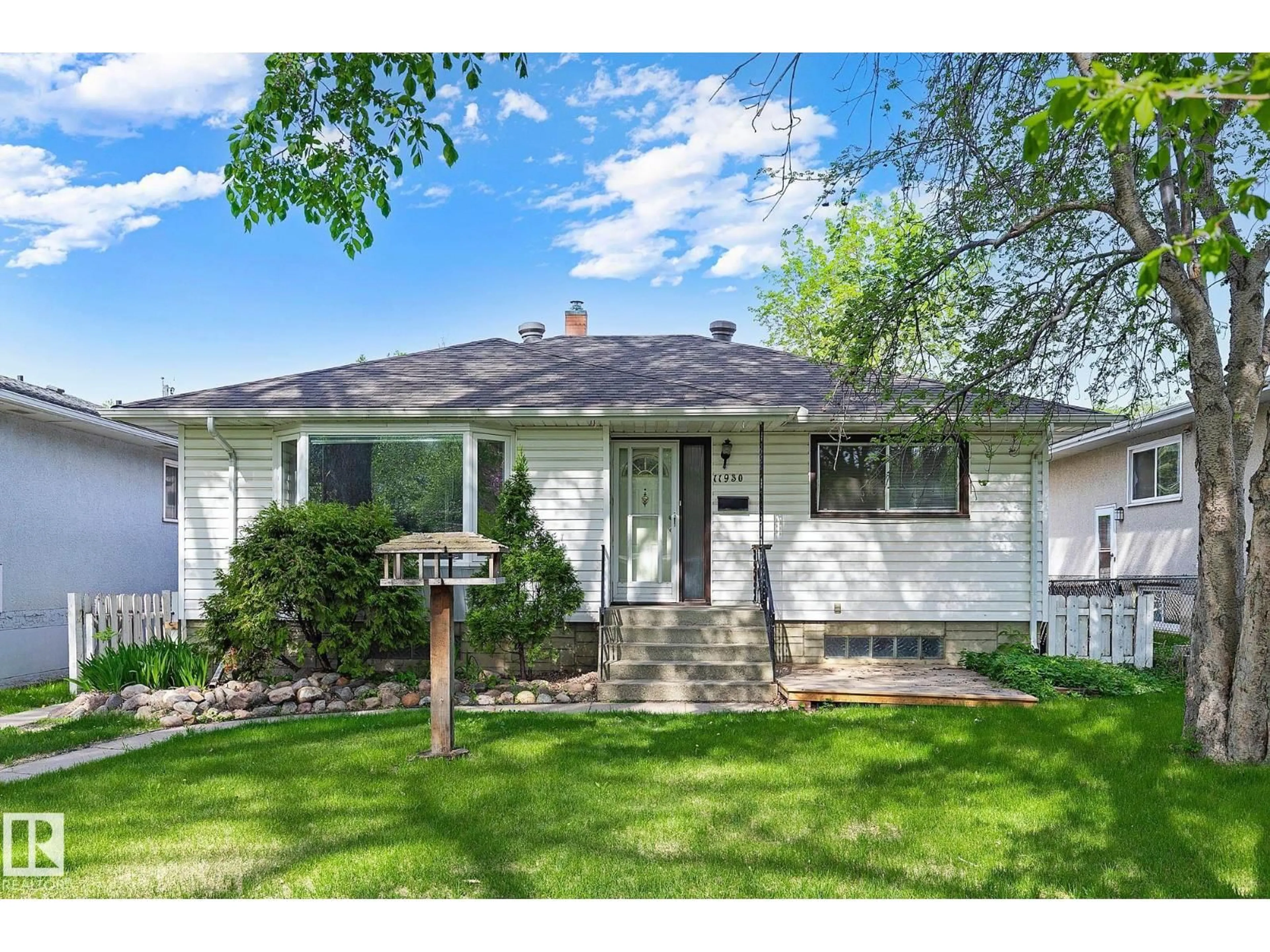 Home with vinyl exterior material, street for 11930 56 ST, Edmonton Alberta T5W3S9