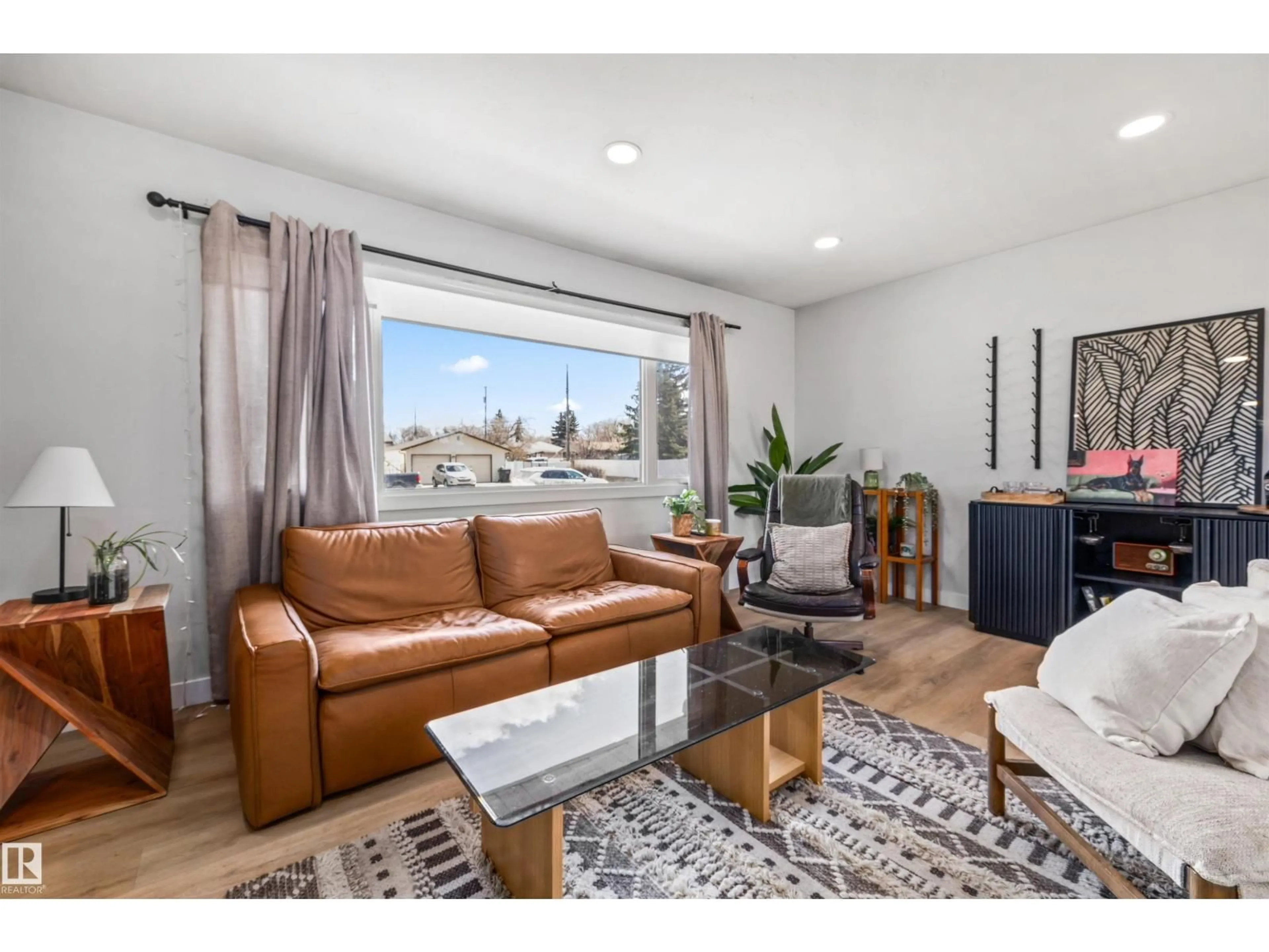 Living room with furniture, wood/laminate floor for NW - 10130 62 ST, Edmonton Alberta T6A2L8