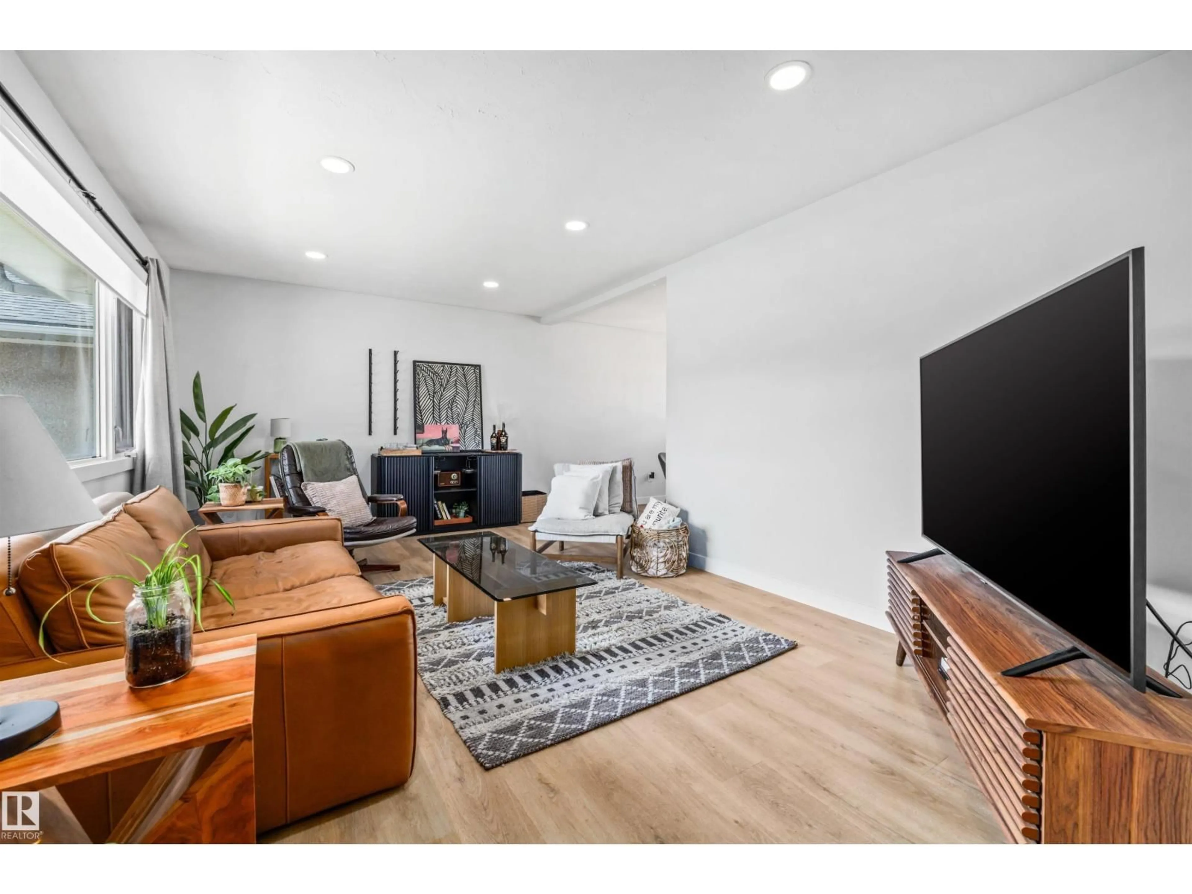 Living room with furniture, wood/laminate floor for NW - 10130 62 ST, Edmonton Alberta T6A2L8