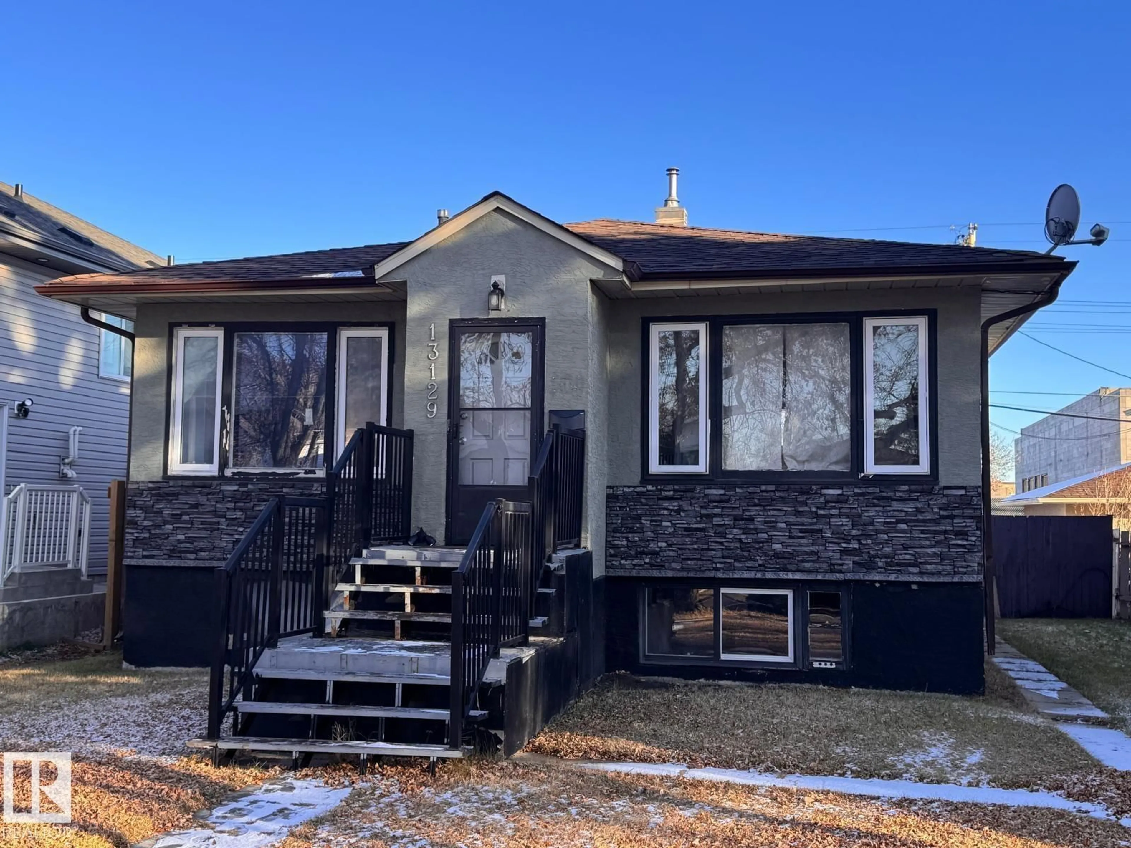 Home with vinyl exterior material, street for 13129 101 ST, Edmonton Alberta T5E4G1