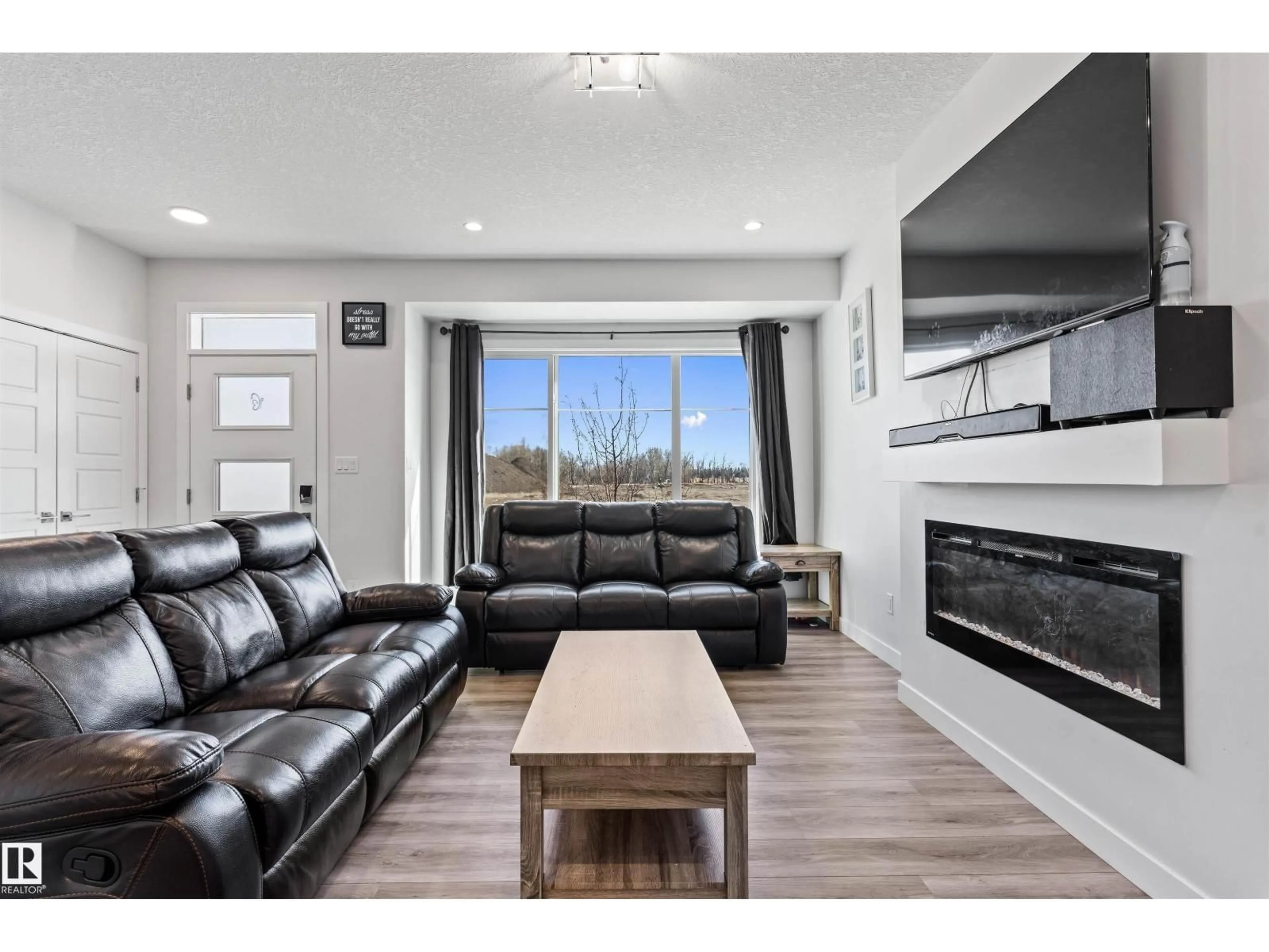 Living room with furniture, wood/laminate floor for SW - 8046 KIRIAK LI, Edmonton Alberta T6W1A5