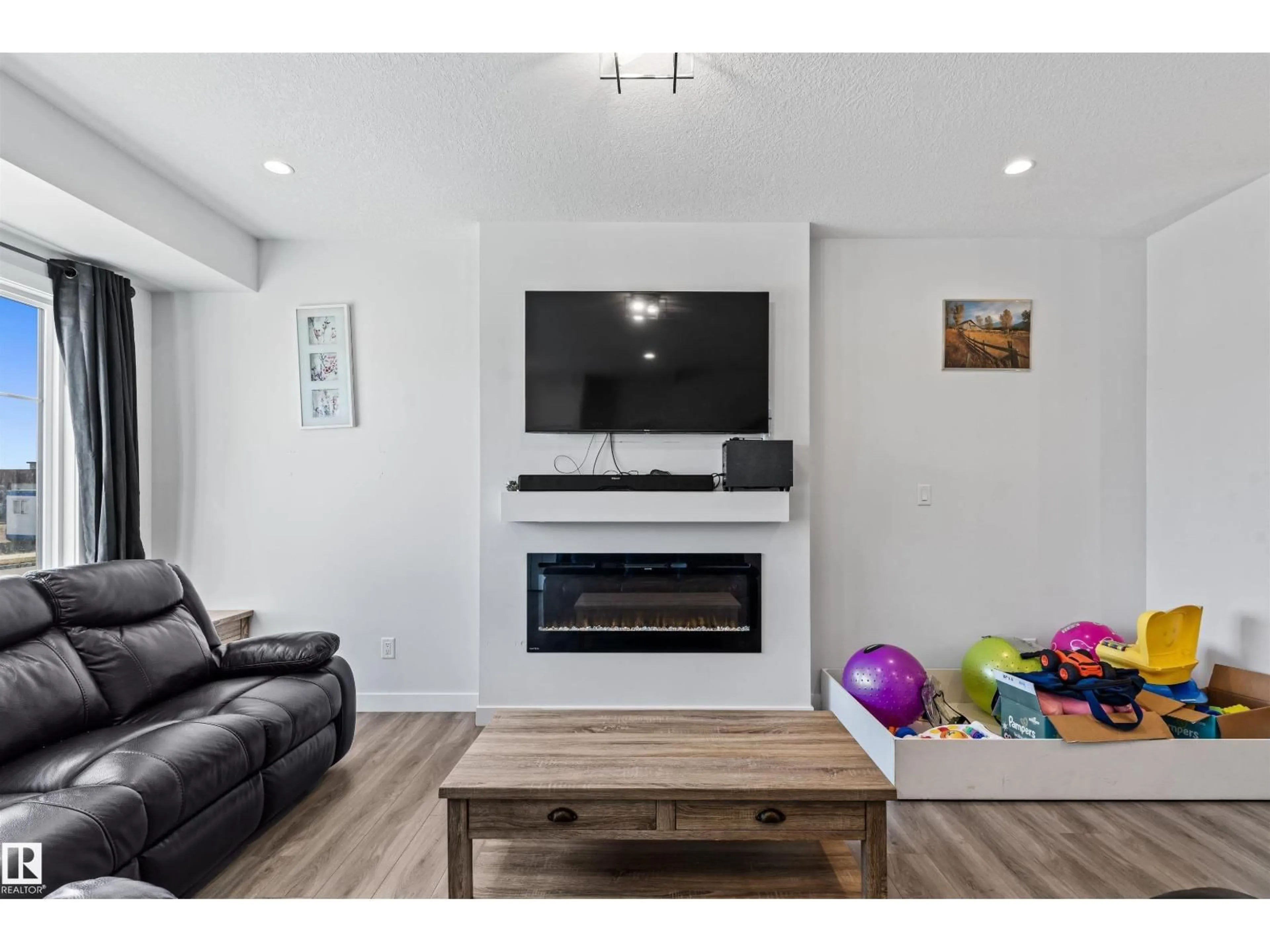 Living room with furniture, wood/laminate floor for SW - 8046 KIRIAK LI, Edmonton Alberta T6W1A5