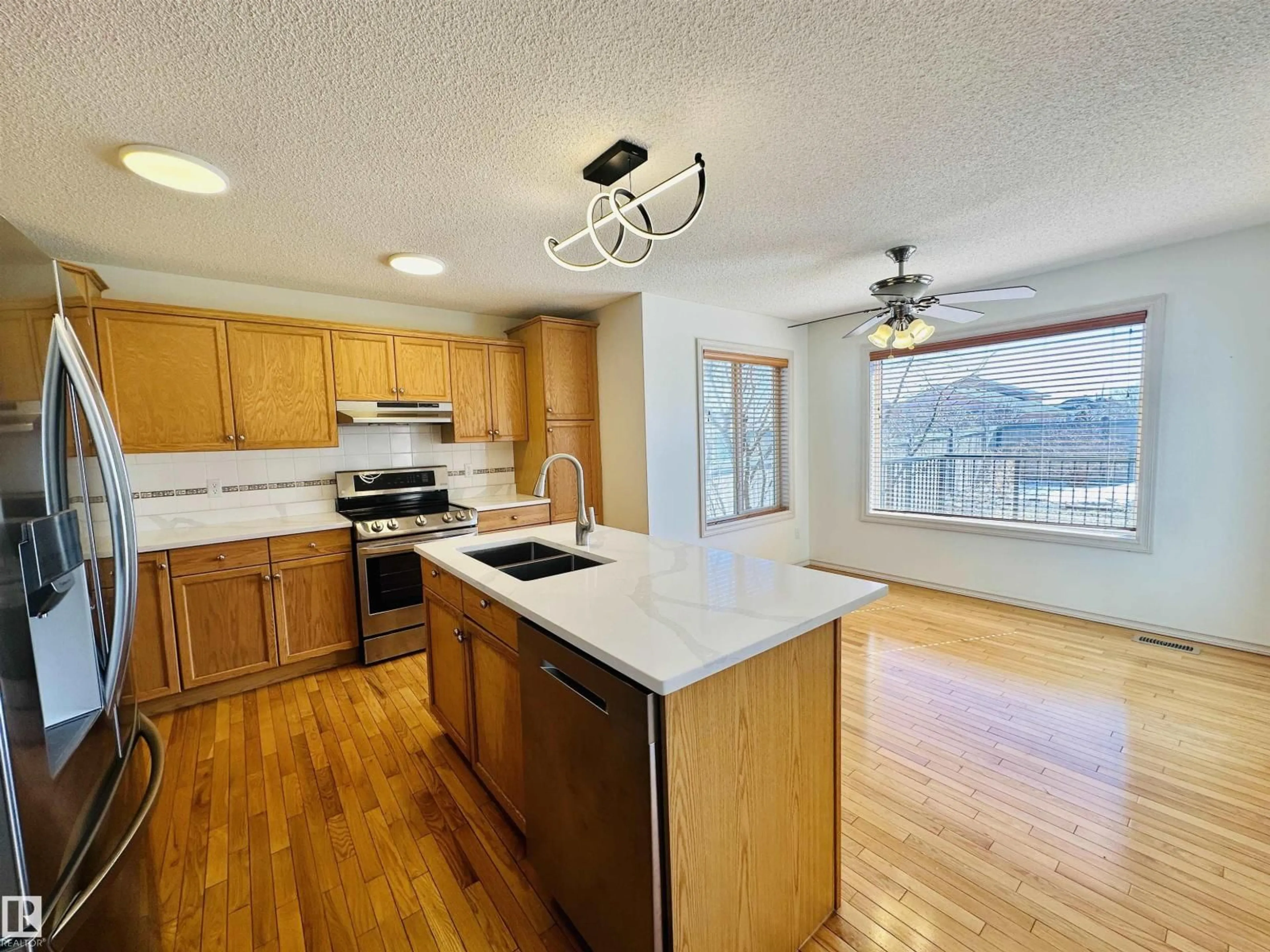 Open concept kitchen, wood/laminate floor for 4811 152 AV, Edmonton Alberta T5Y3B8