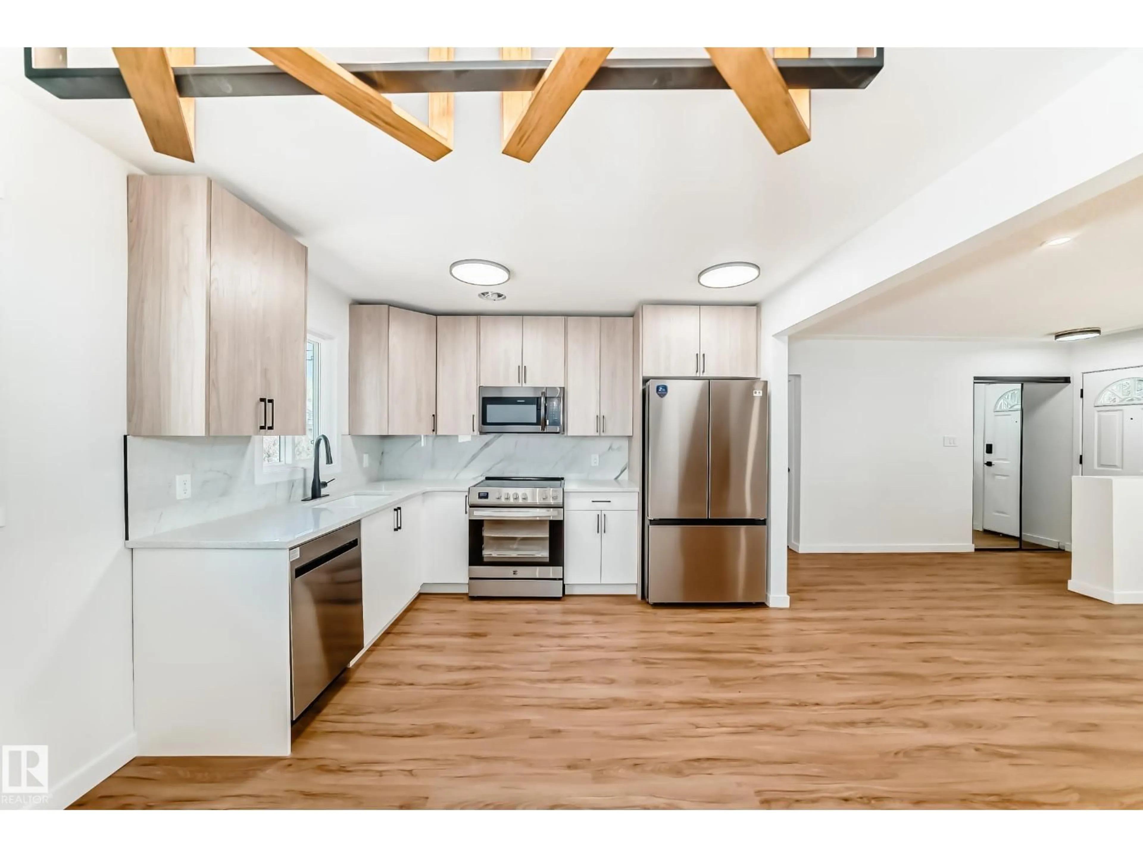Open concept kitchen, wood/laminate floor for 4842 116 AVE, Edmonton Alberta T5W0X6