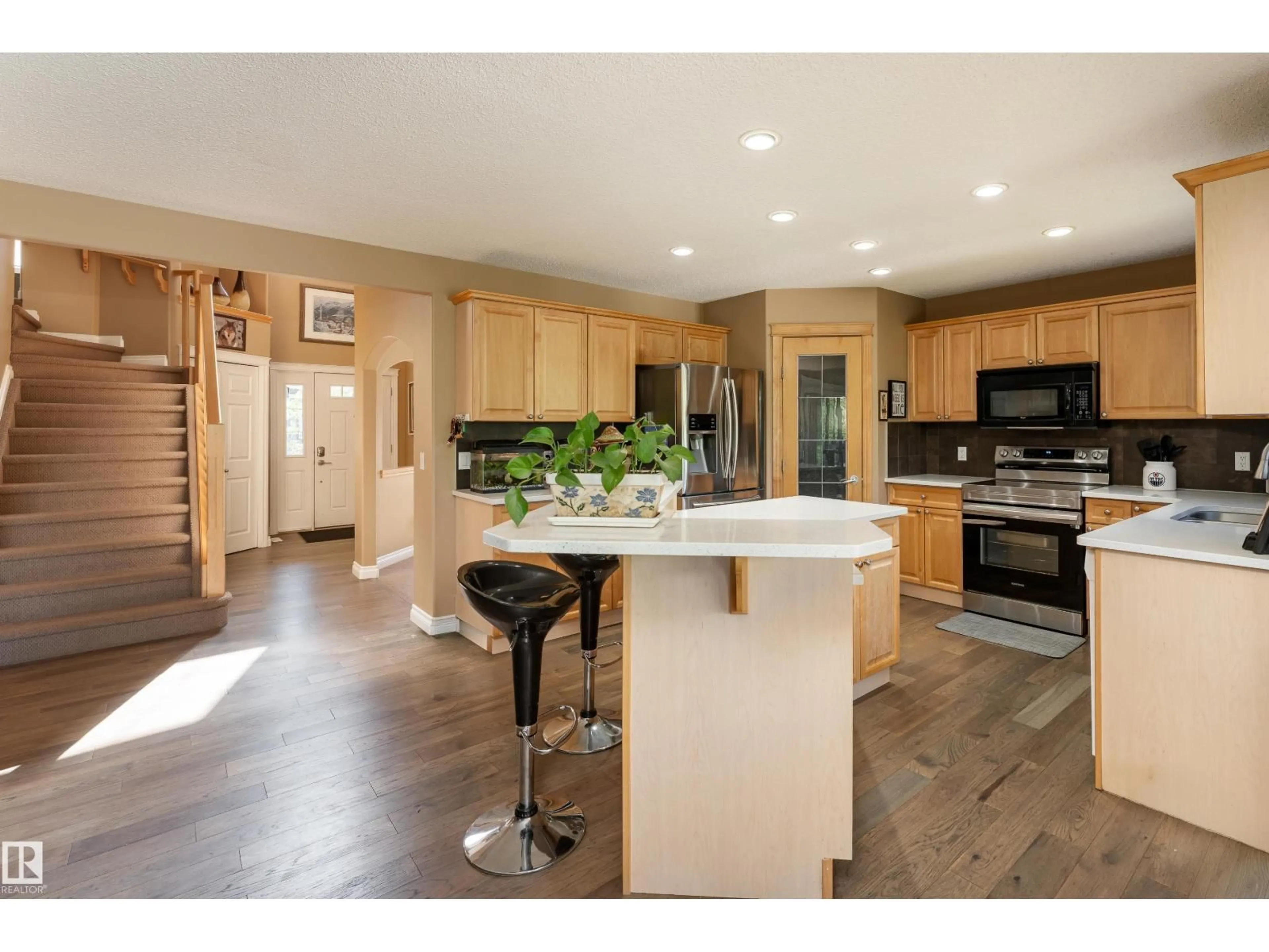 Open concept kitchen, wood/laminate floor for 5108 63 ST, Beaumont Alberta T4X1V4