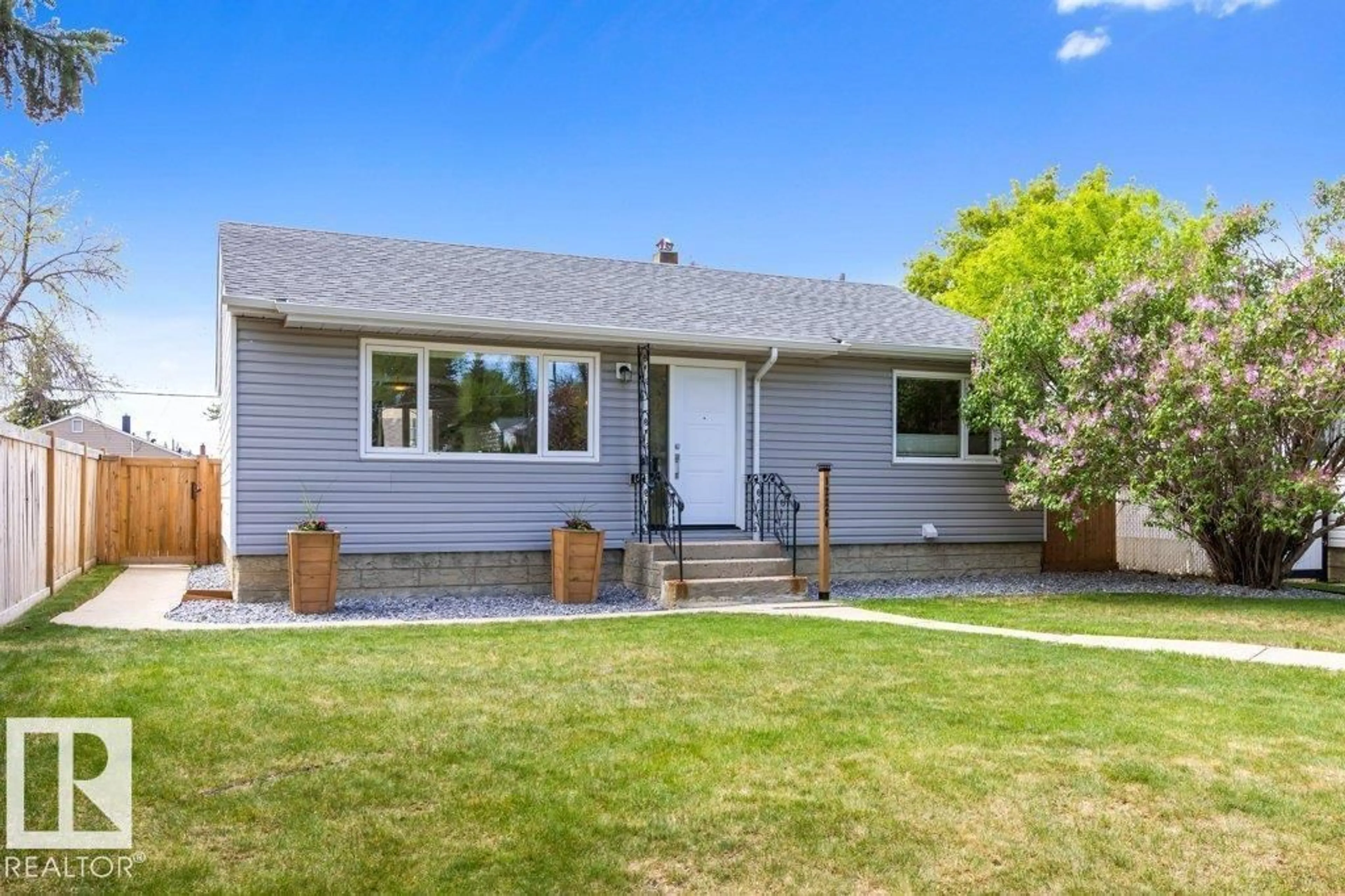 Home with vinyl exterior material, street for 12264 135 ST, Edmonton Alberta T5L1X2