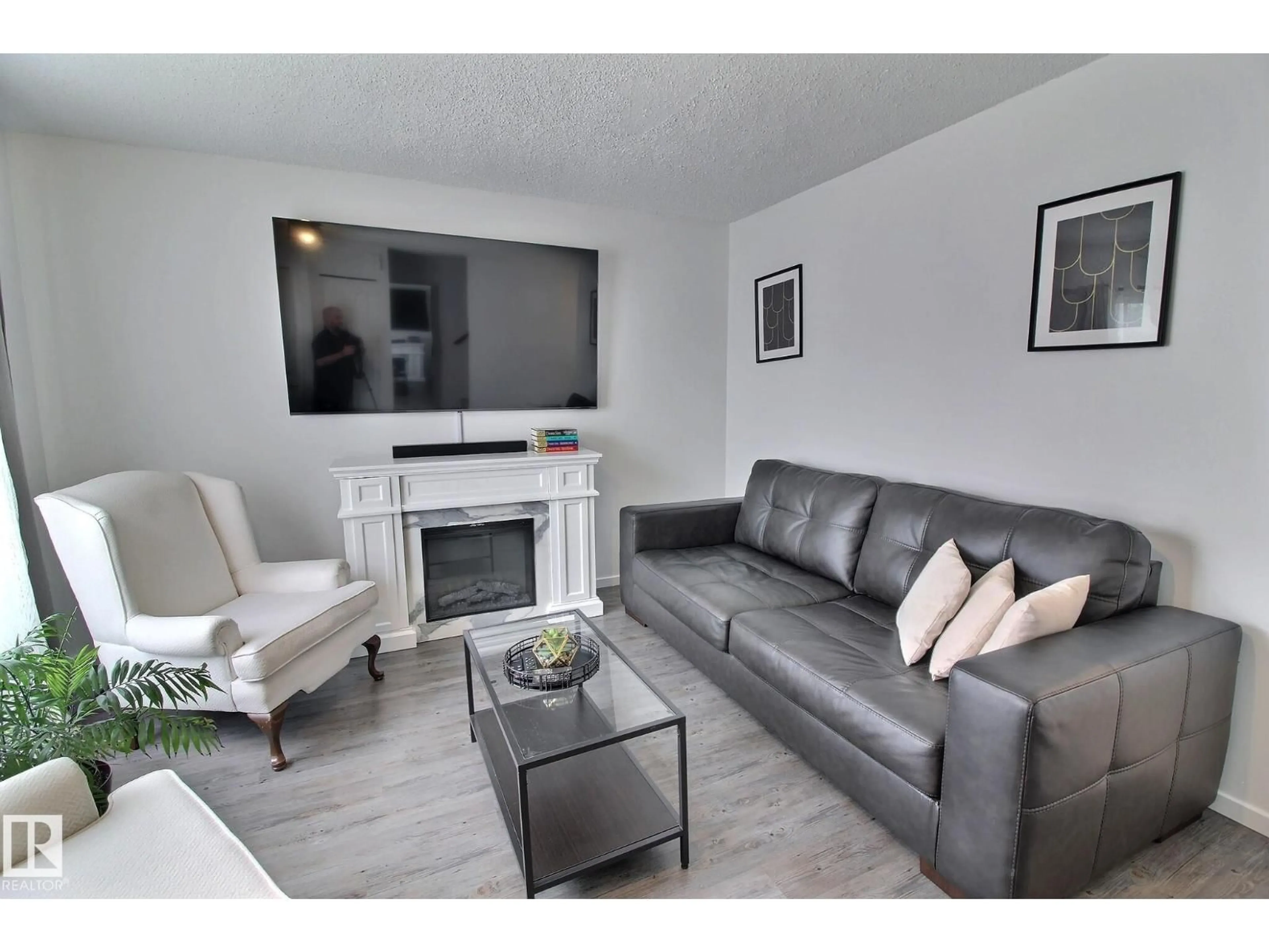 Living room with furniture, wood/laminate floor for 701 - 610 KING ST, Spruce Grove Alberta T7Z4J9