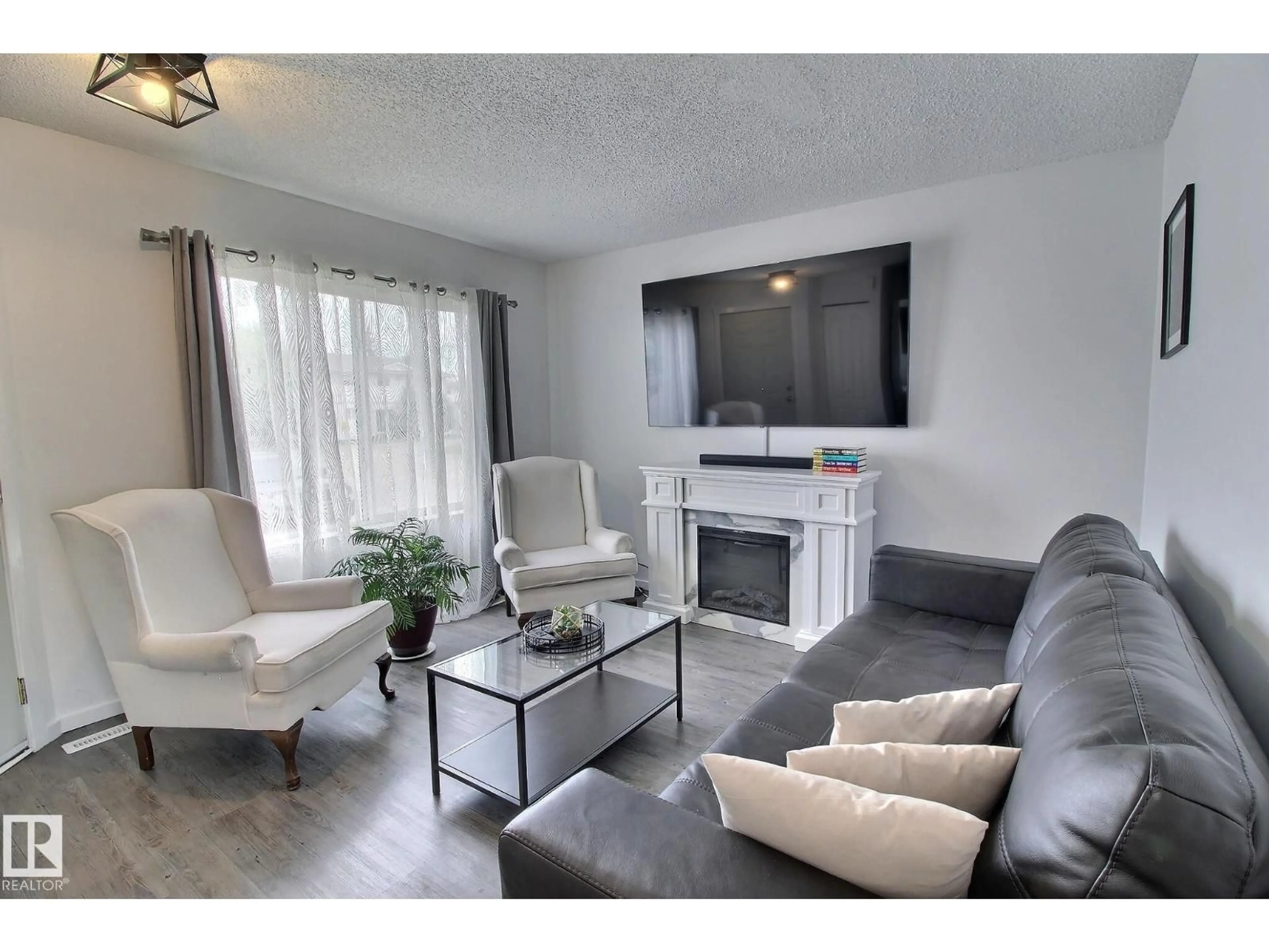 Living room with furniture, wood/laminate floor for 701 - 610 KING ST, Spruce Grove Alberta T7Z4J9
