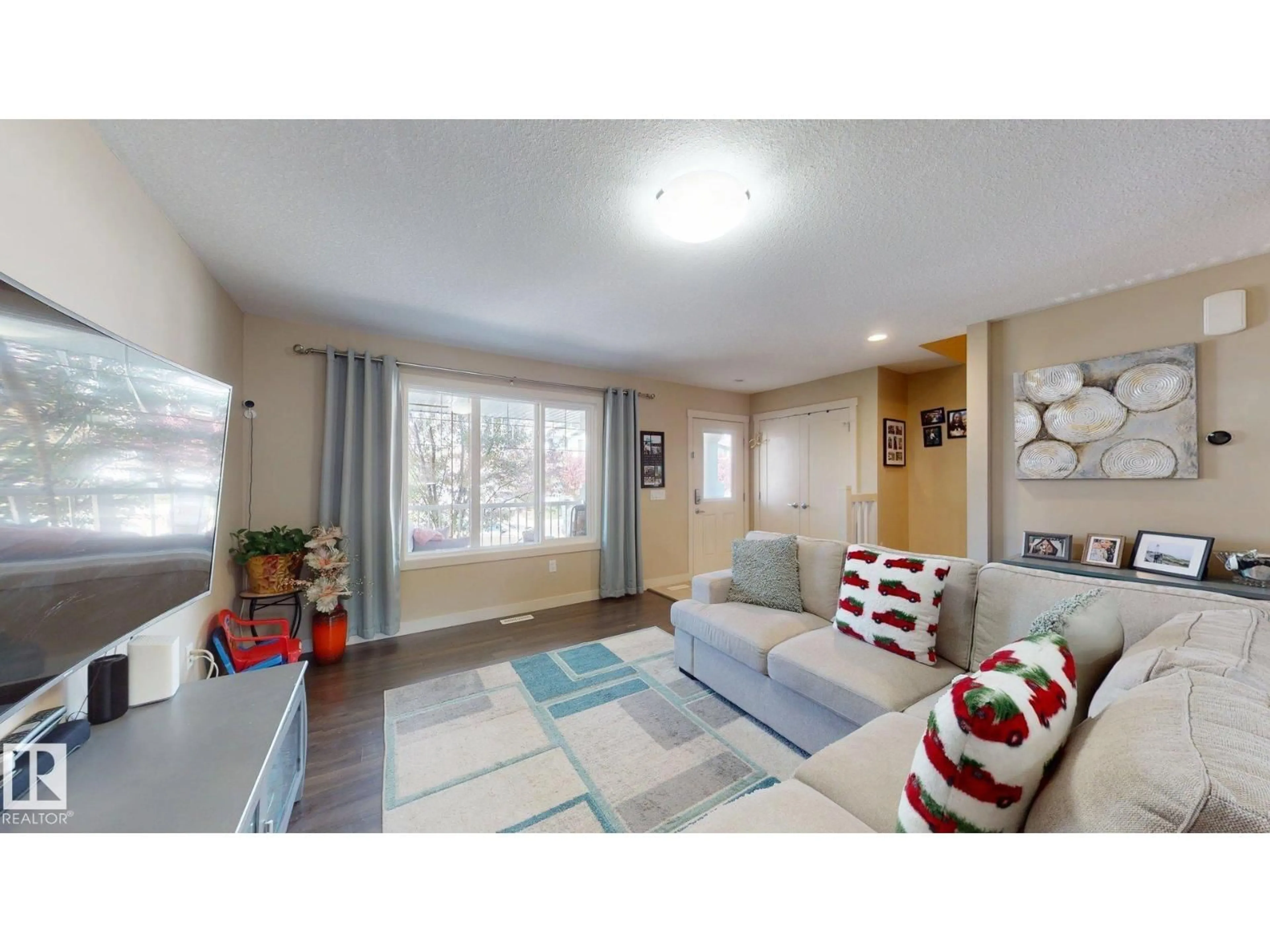 Living room with furniture, wood/laminate floor for 6824 EVANS WD, Edmonton Alberta T6M0T3