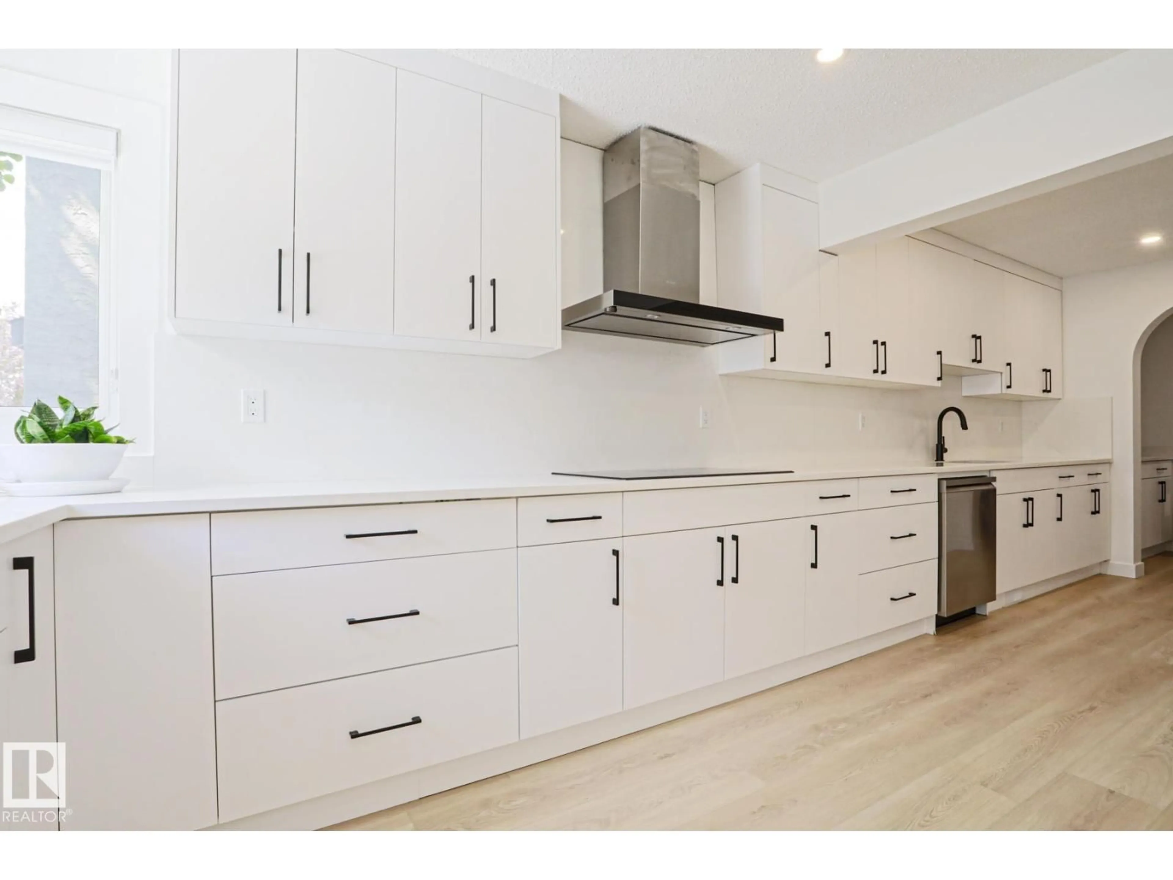 Open concept kitchen, wood/laminate floor for 11347 10 AV, Edmonton Alberta T6J6S9