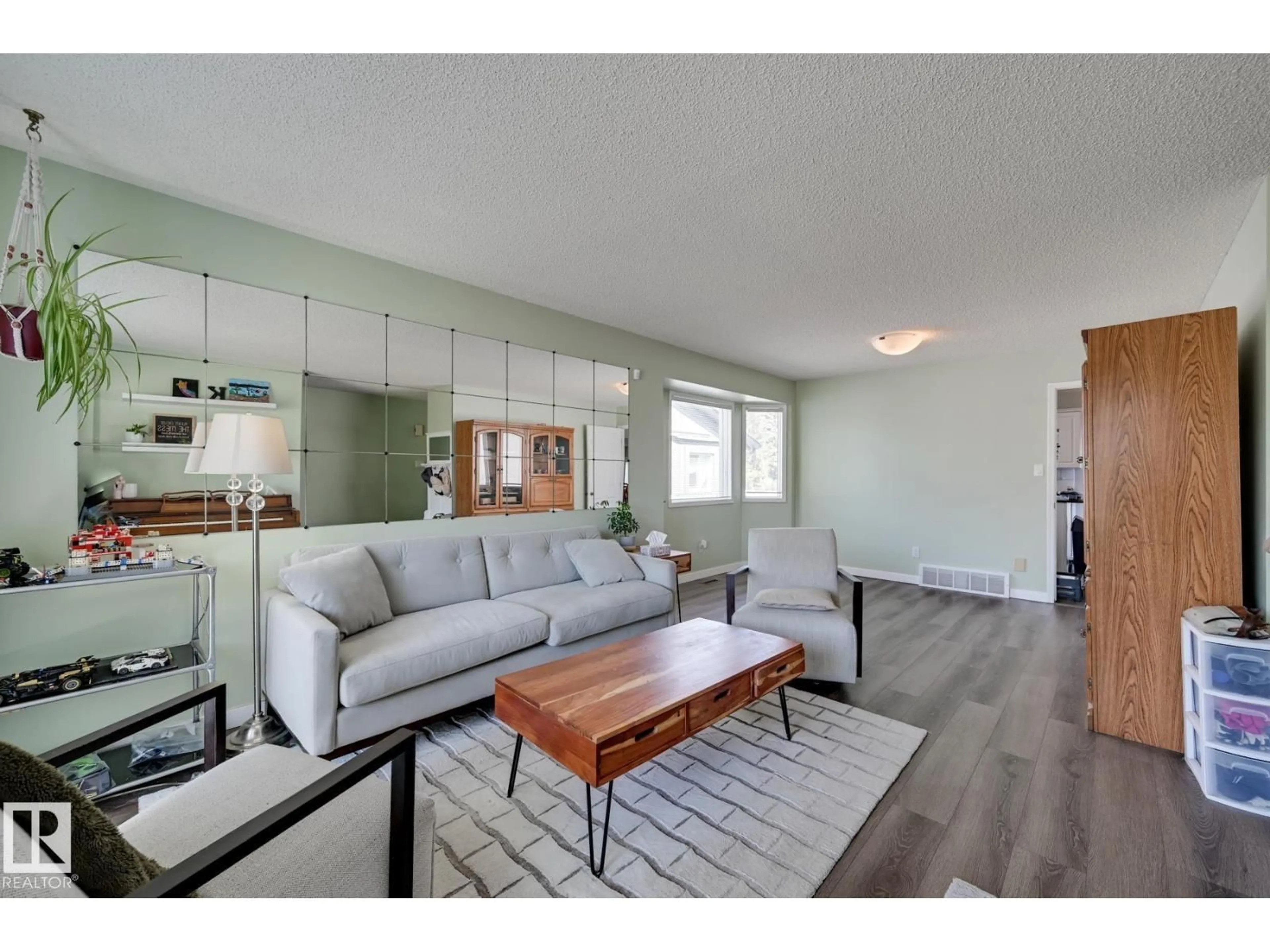 Living room with furniture, wood/laminate floor for NW - 5507 179 ST, Edmonton Alberta T6M1X1
