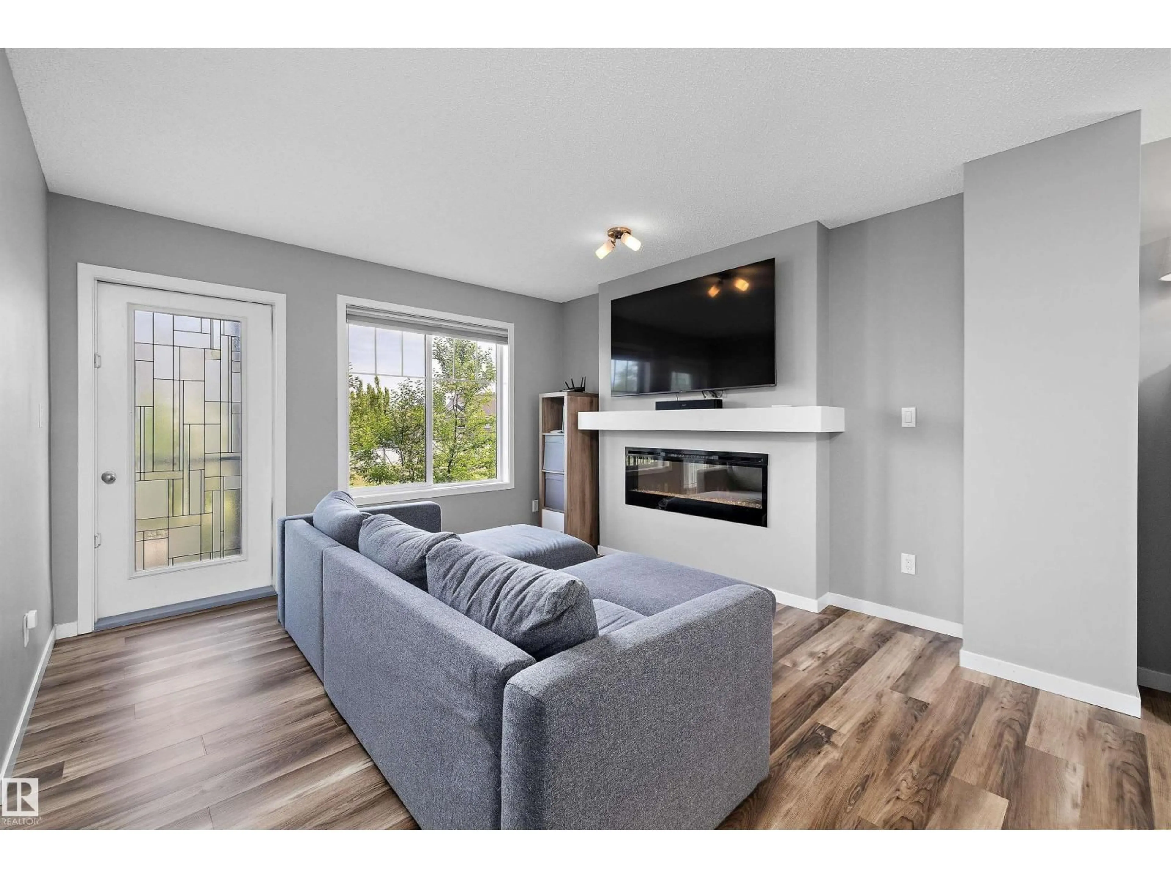 Living room with furniture, wood/laminate floor for #128 - 3305 ORCHARDS LINK LI, Edmonton Alberta T6X2H1