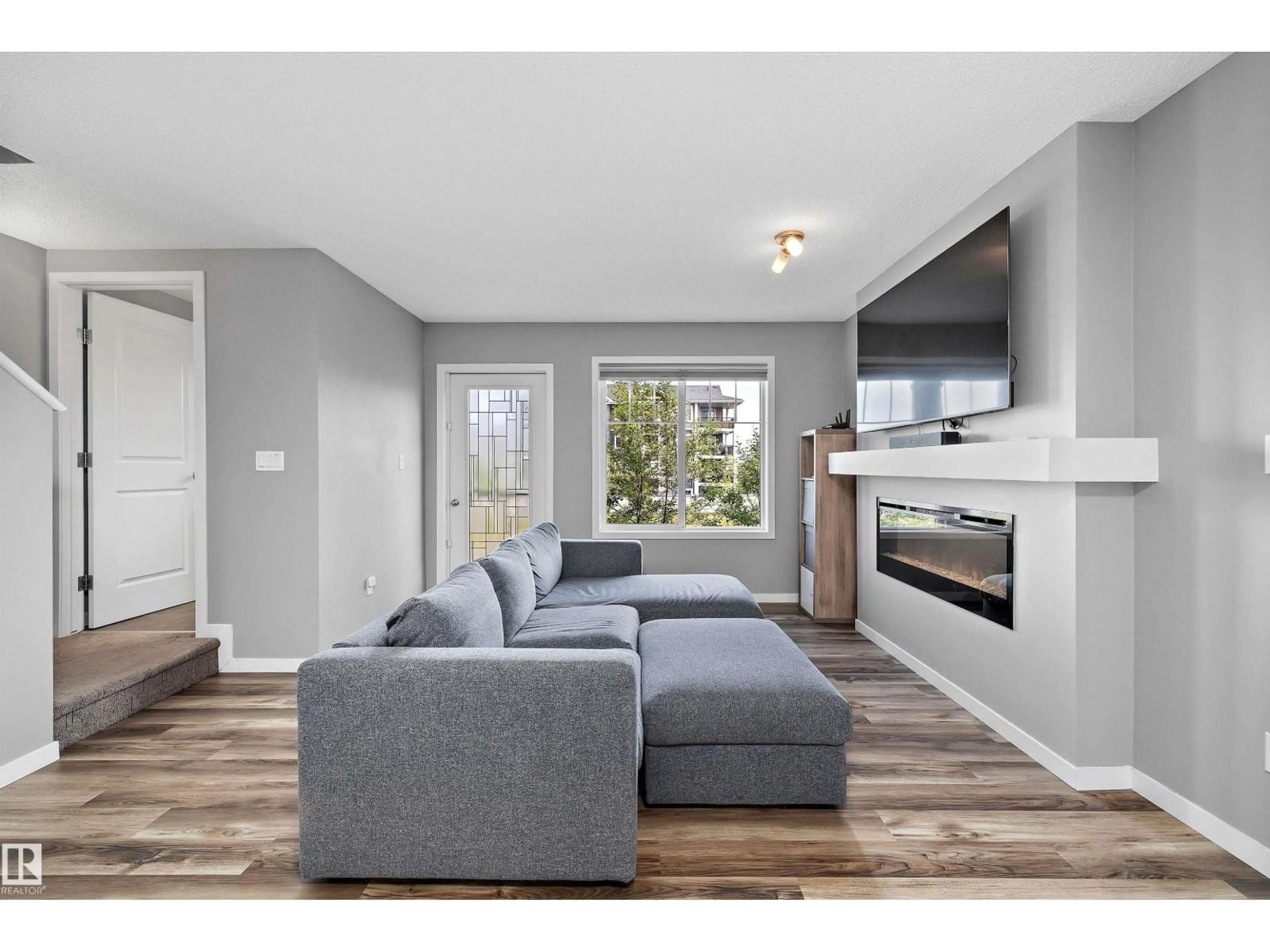 Living room with furniture, wood/laminate floor for #128 - 3305 ORCHARDS LINK LI, Edmonton Alberta T6X2H1