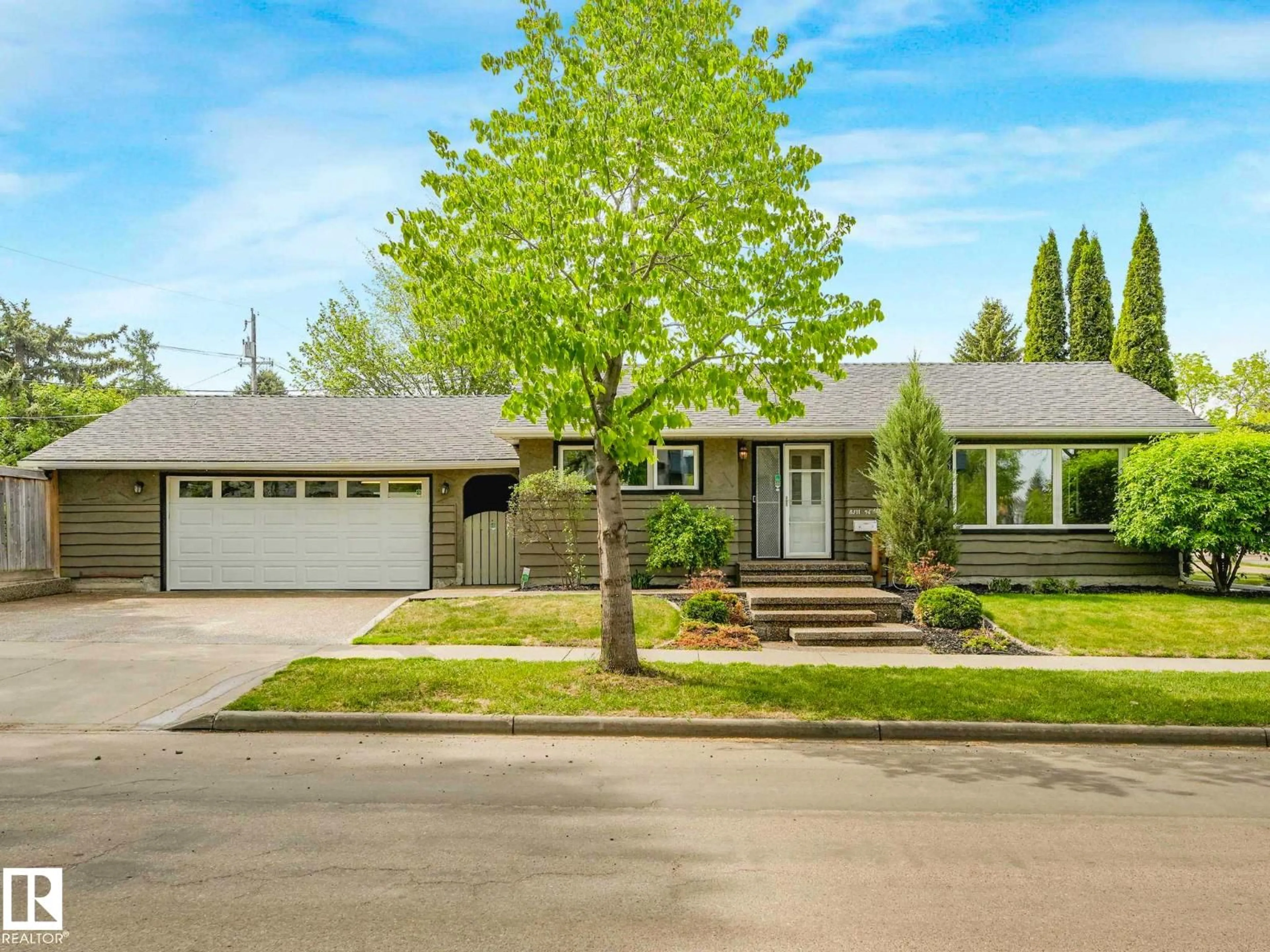 Home with vinyl exterior material, street for 8311 96 AV NW, Edmonton Alberta T6C2A9