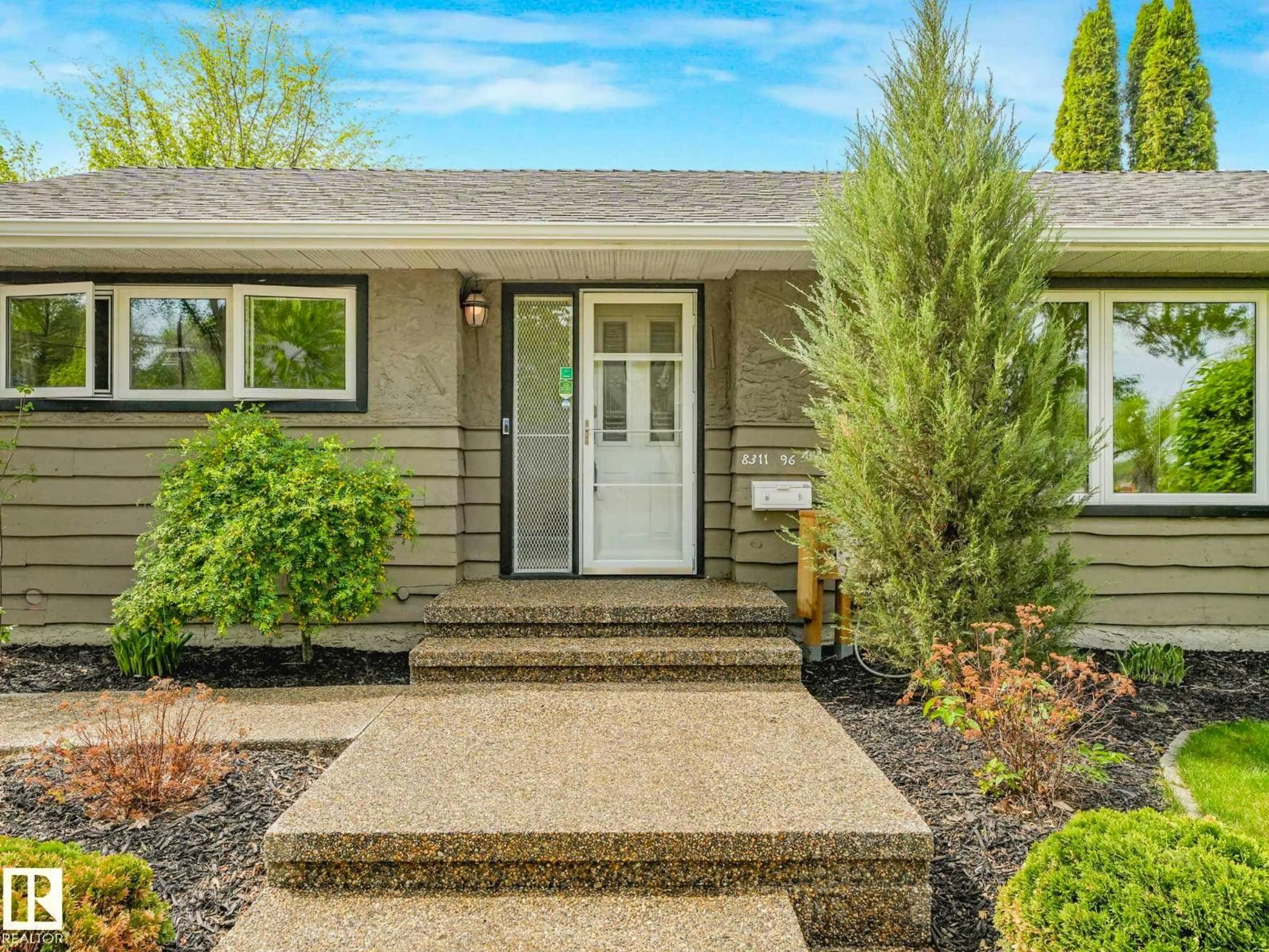Home with vinyl exterior material, street for 8311 96 AV NW, Edmonton Alberta T6C2A9