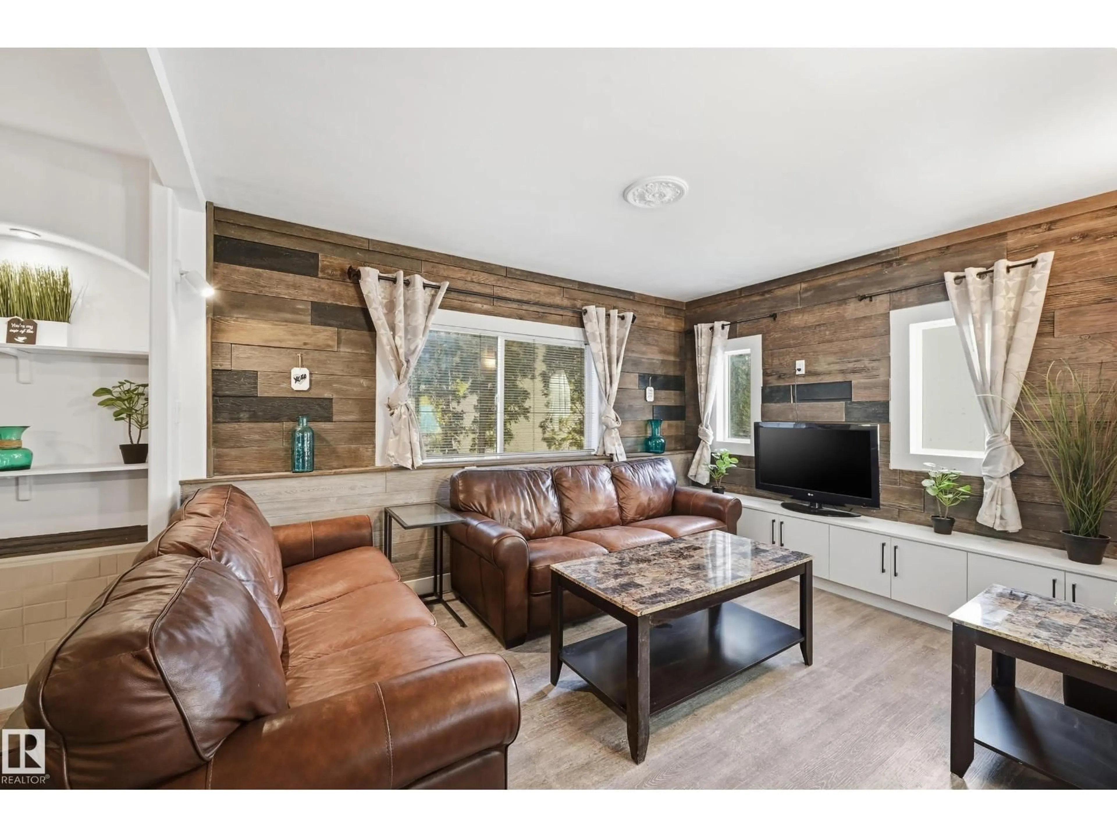 Living room with furniture, wood/laminate floor for 10656 93 ST, Edmonton Alberta T5H1X9