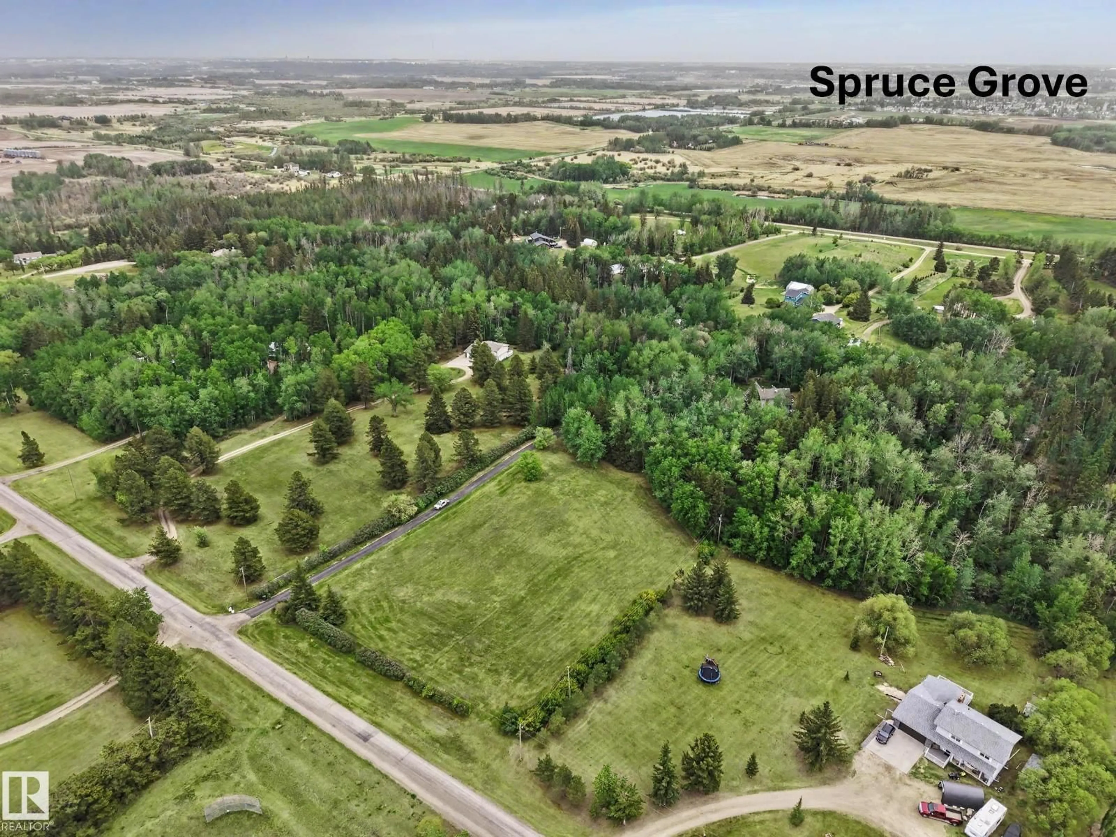 A pic from outside/outdoor area/front of a property/back of a property/a pic from drone, forest/trees view for 17 - 53412 RGE ROAD 272, Rural Parkland County Alberta T7X3N2