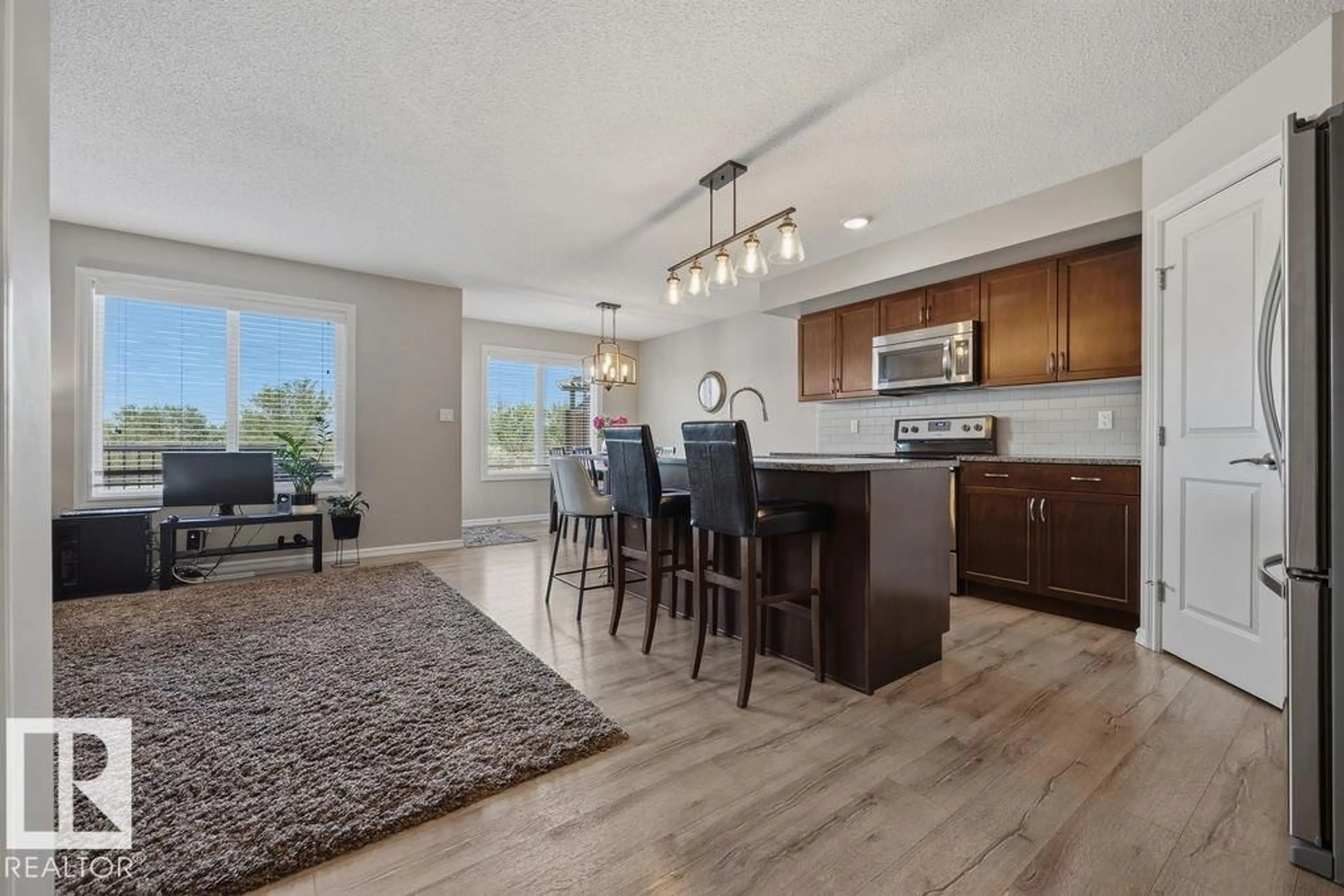 Open concept kitchen, wood/laminate floor for 5806 66 ST, Beaumont Alberta T4X2A4