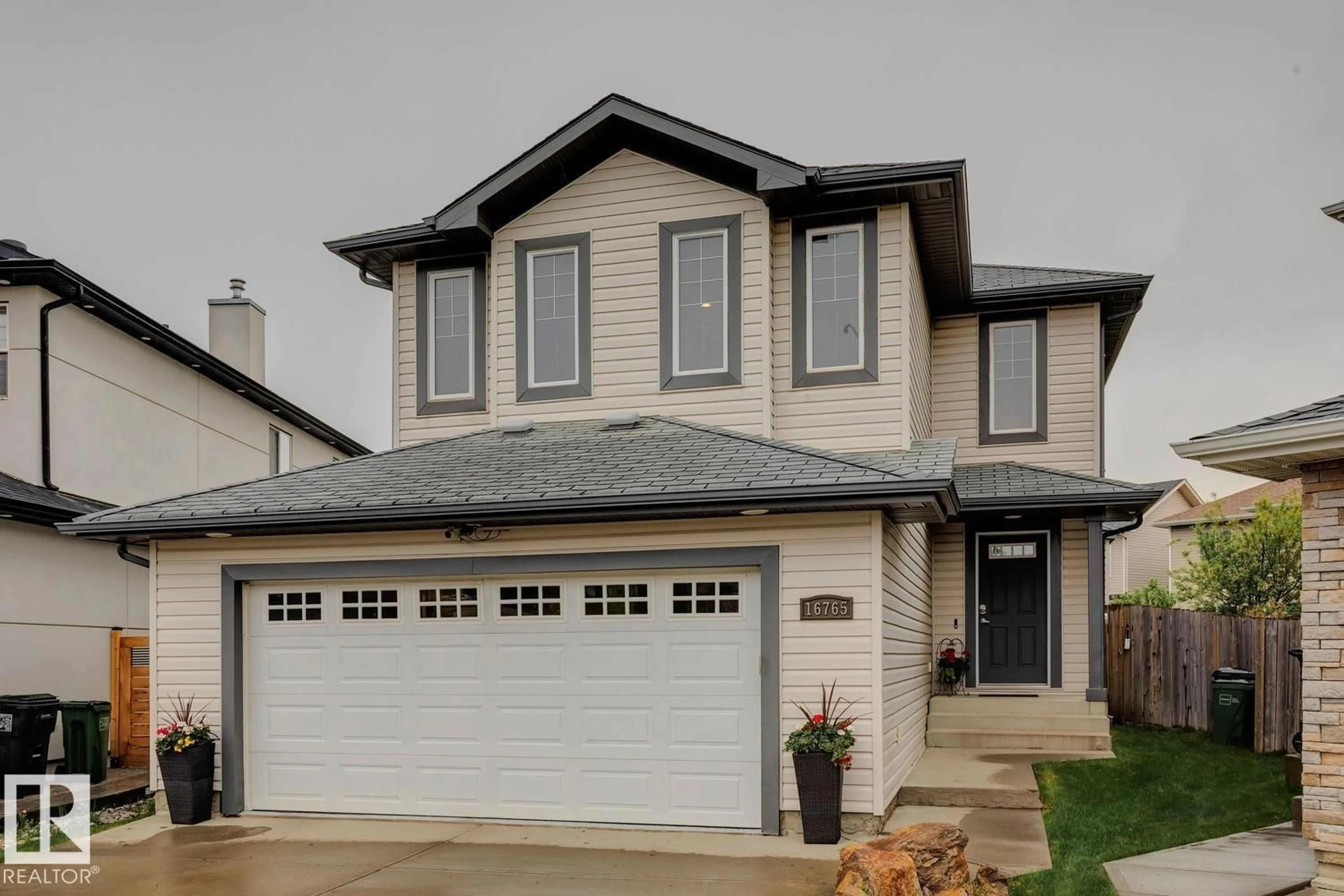 Home with vinyl exterior material, street for 16765 119 ST NW, Edmonton Alberta T5X6K4