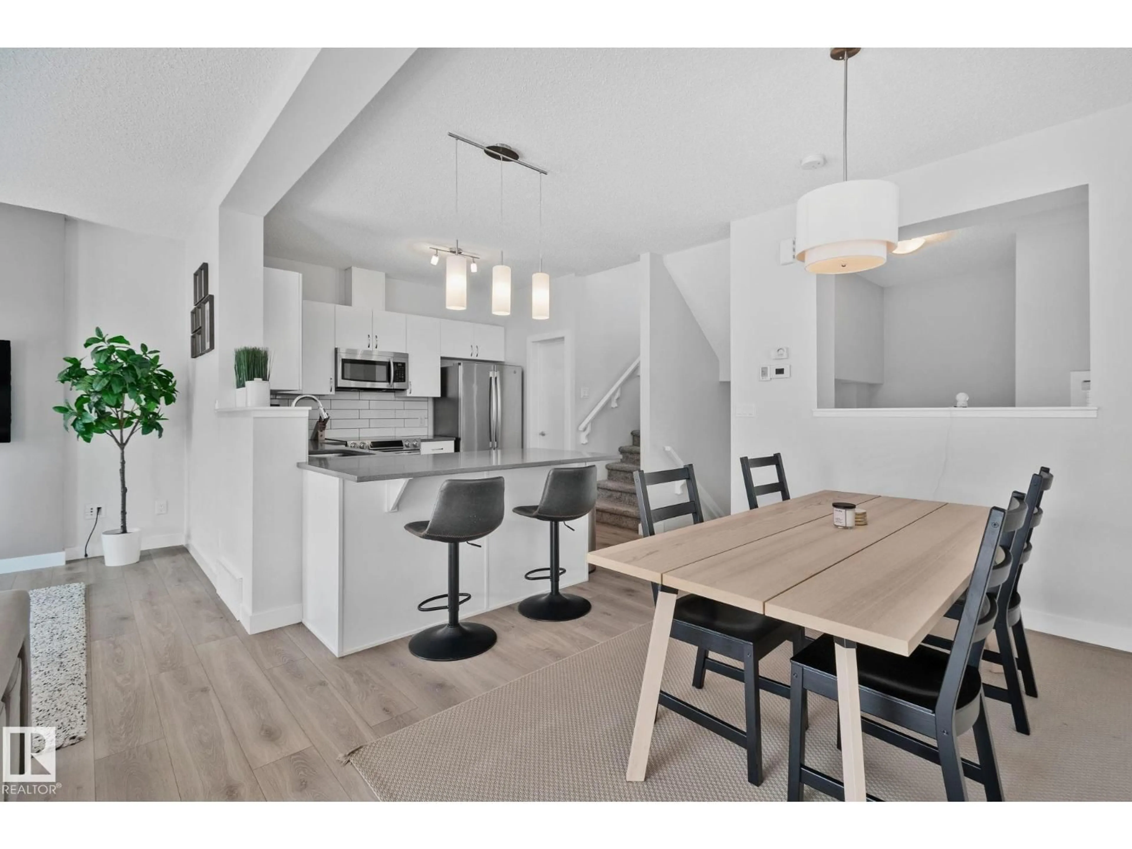 Open concept kitchen, wood/laminate floor for 249 39A AV AV, Edmonton Alberta T6T2K3