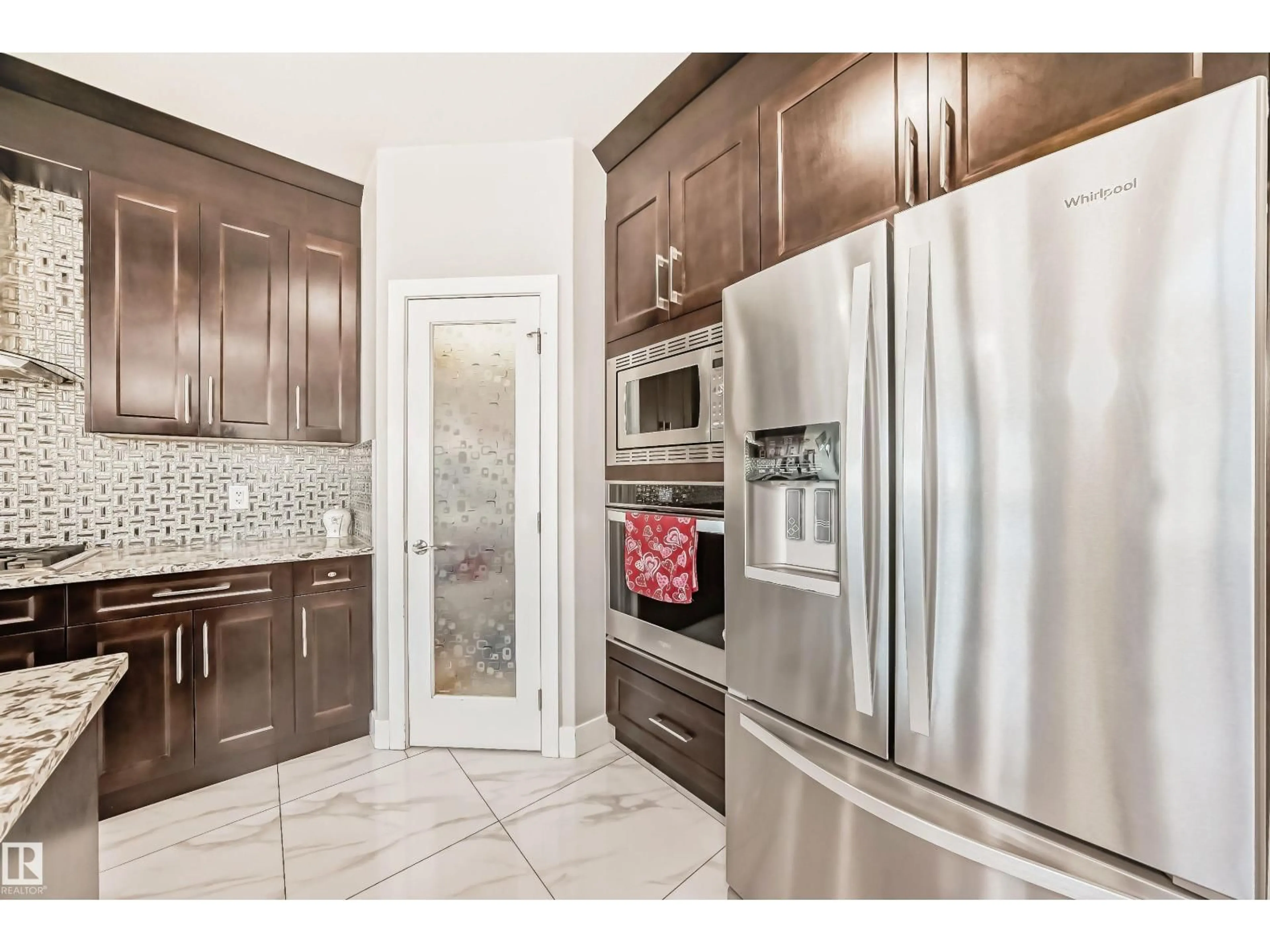 Open concept kitchen, ceramic/tile floor for 2464 15 AV, Edmonton Alberta T6T2L3