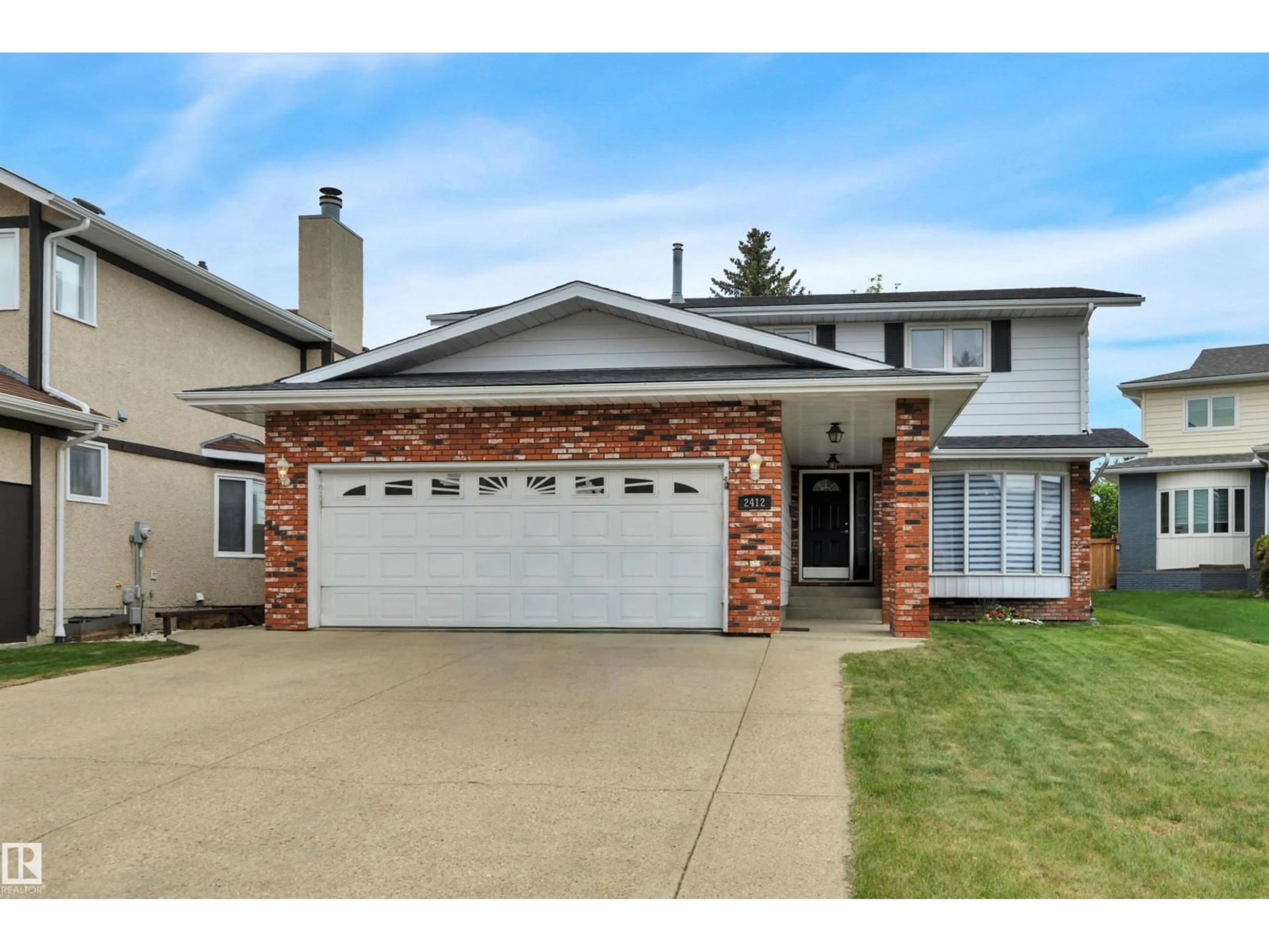 Home with vinyl exterior material, street for NW - 2412 112A ST, Edmonton Alberta T6J4W1