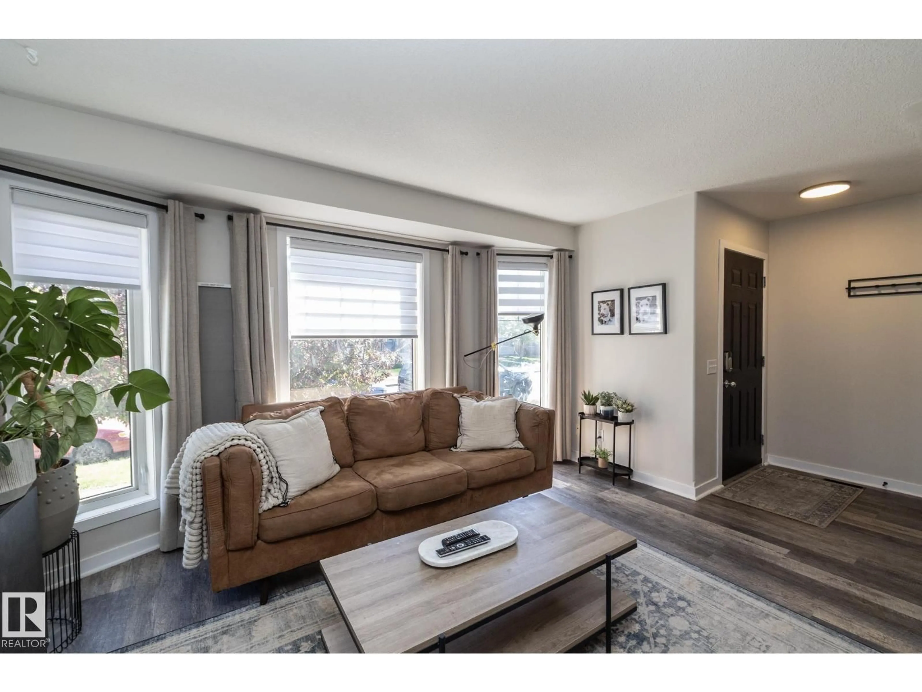 Living room with furniture, wood/laminate floor for NW - 4204 161 AV, Edmonton Alberta T5Y0G5