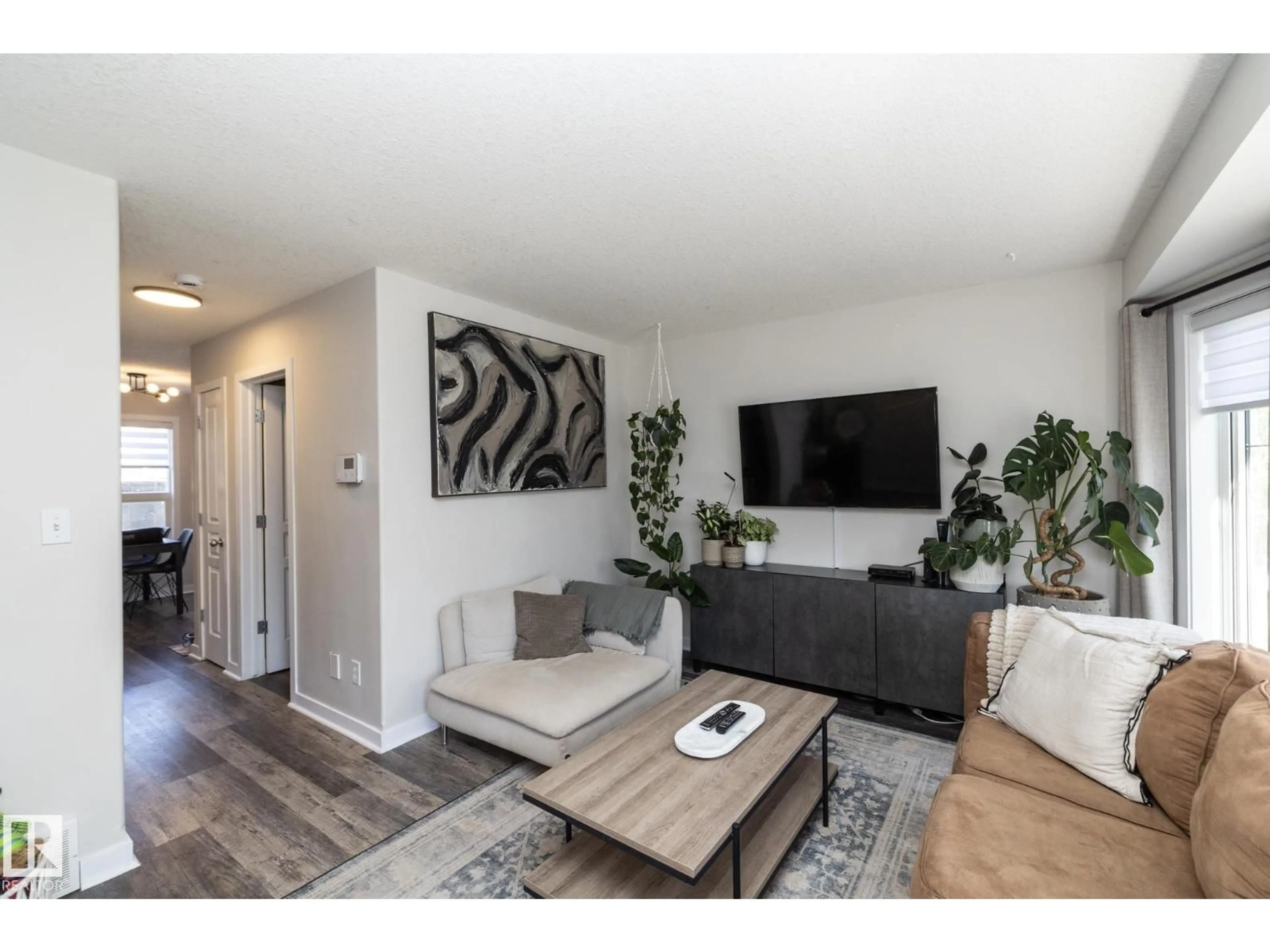 Living room with furniture, wood/laminate floor for NW - 4204 161 AV, Edmonton Alberta T5Y0G5