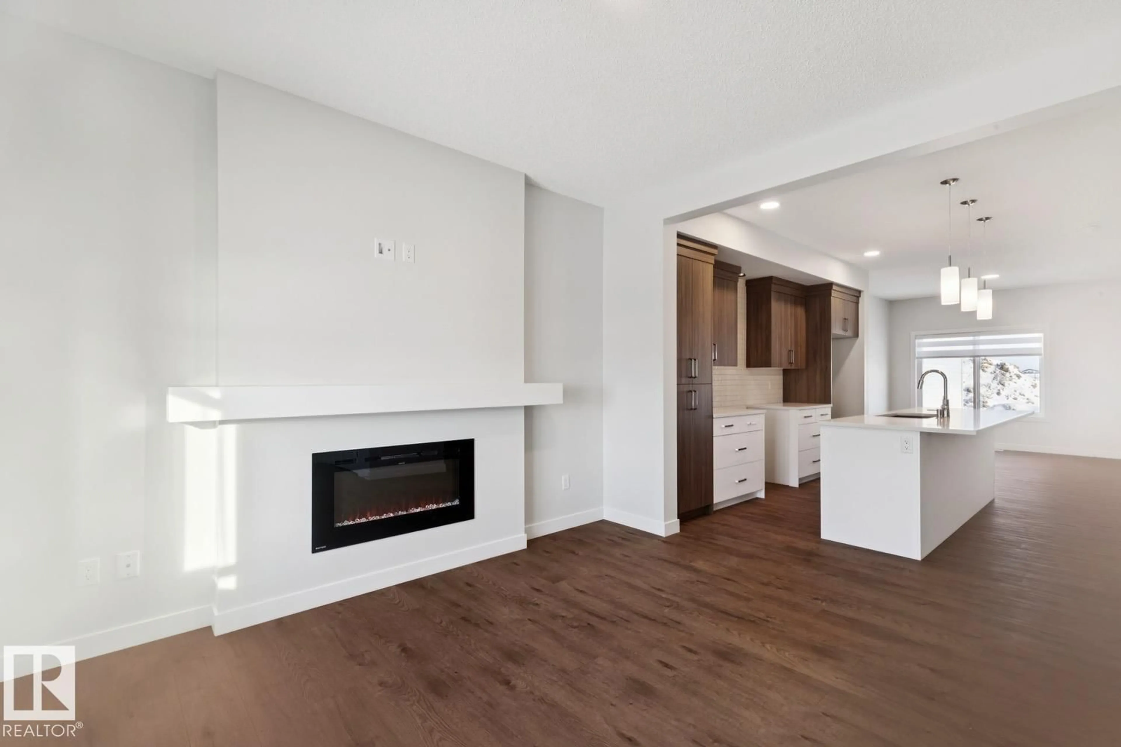 Open concept kitchen, wood/laminate floor for 1081 BERG PL, Leduc Alberta T9E1T6