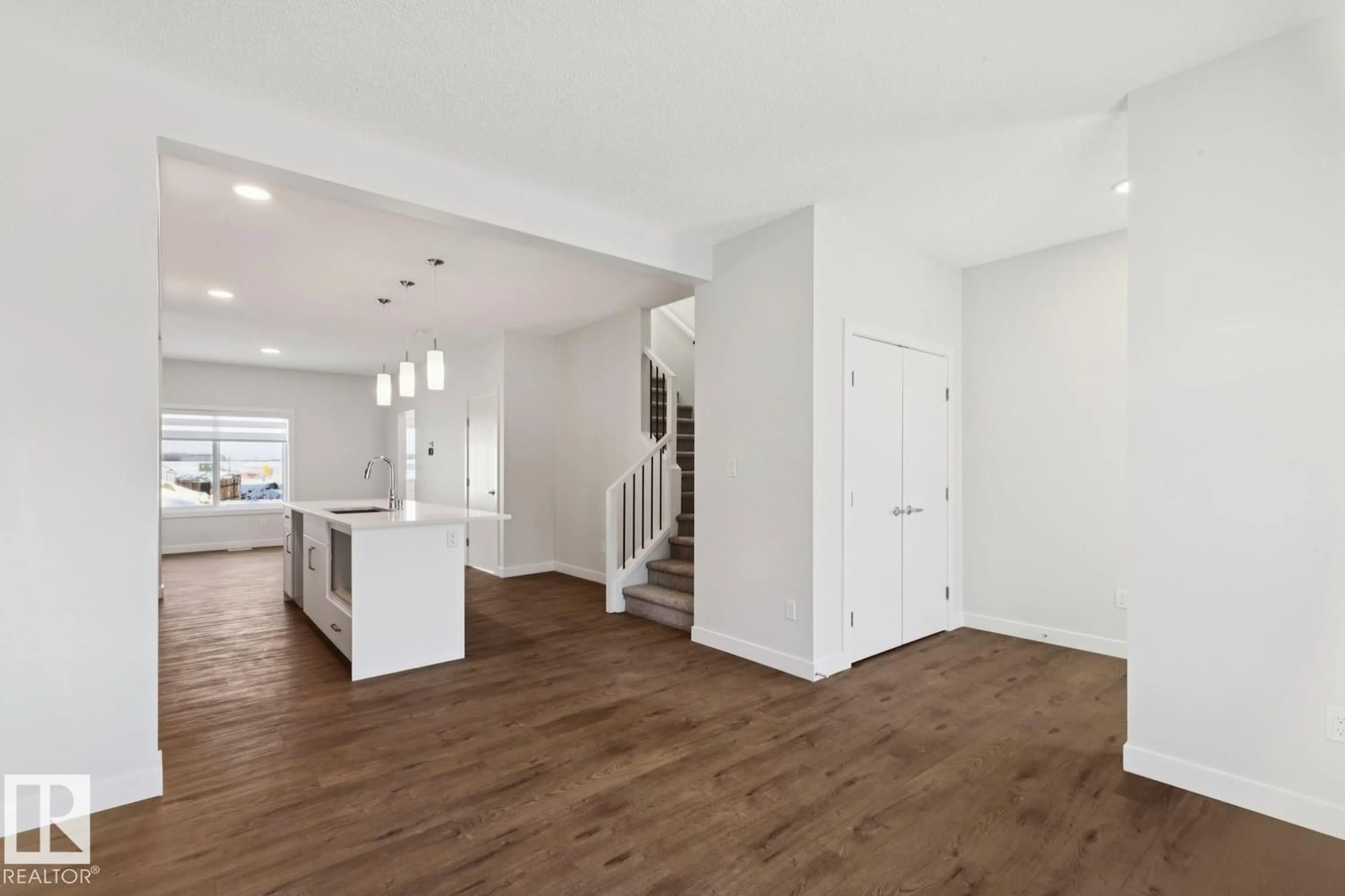 Open concept kitchen, wood/laminate floor for 1081 BERG PL, Leduc Alberta T9E1T6