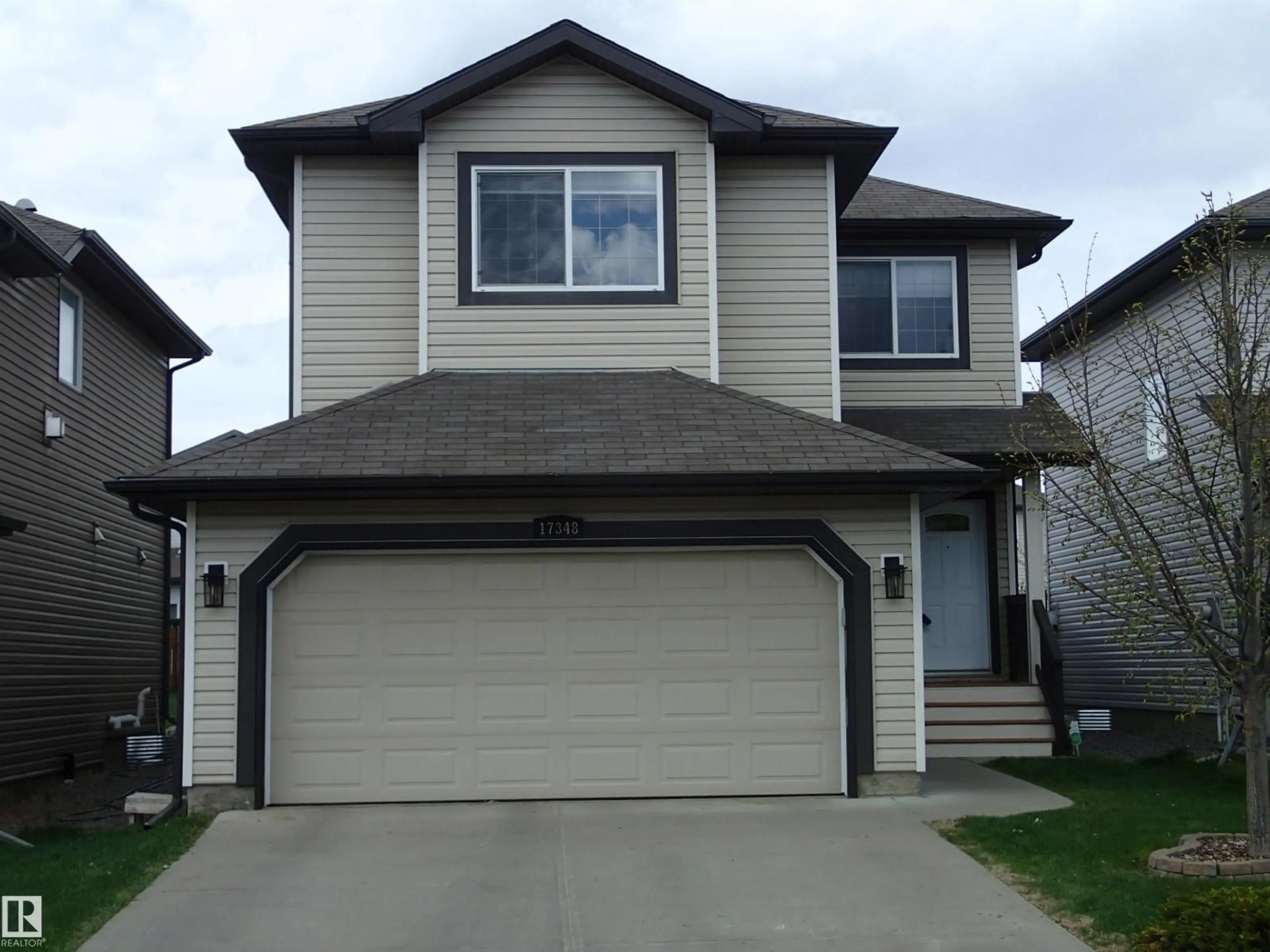 Home with vinyl exterior material, street for 17348 8 AV, Edmonton Alberta T6W0M9