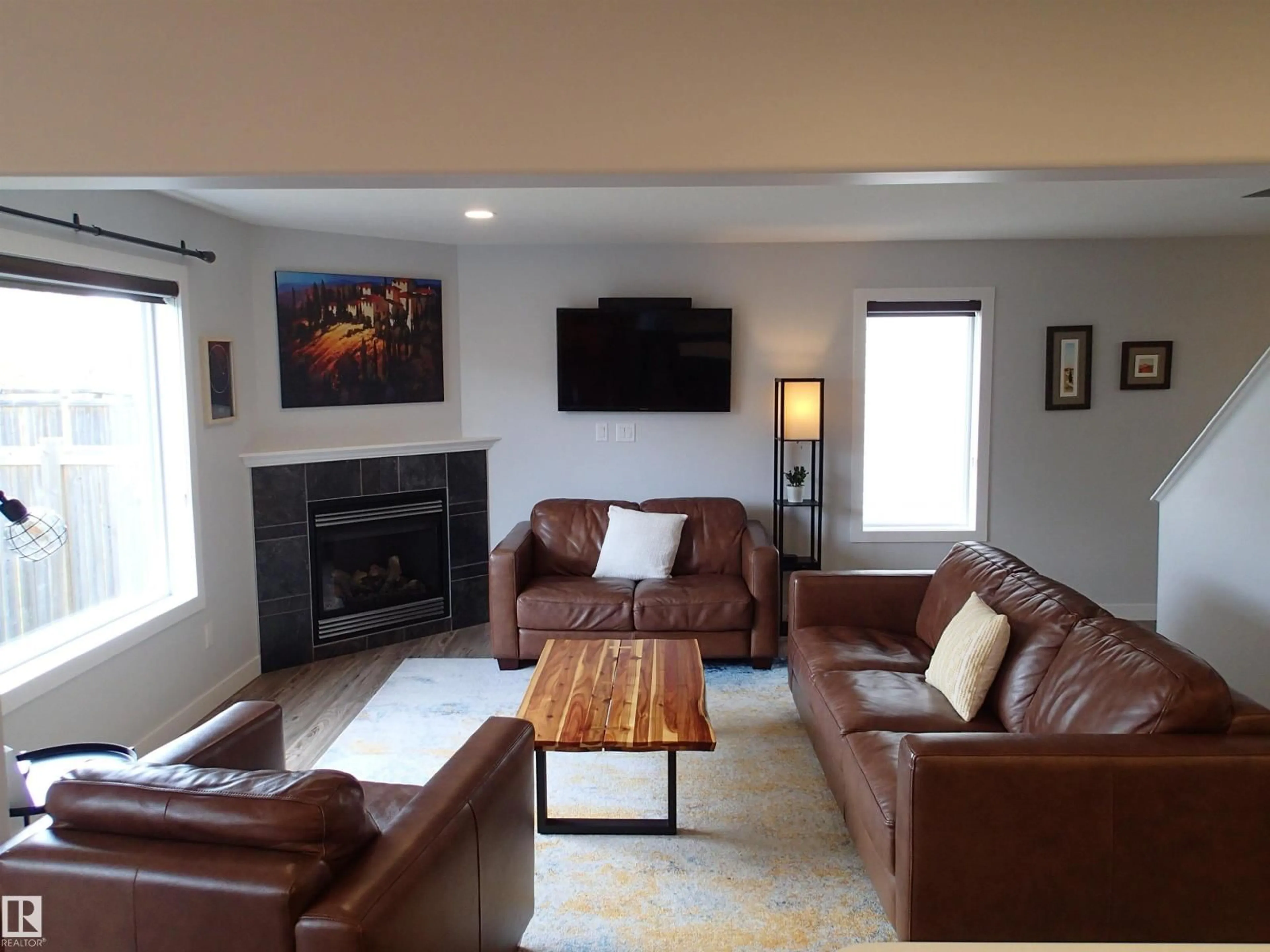 Living room with furniture, wood/laminate floor for 17348 8 AV, Edmonton Alberta T6W0M9