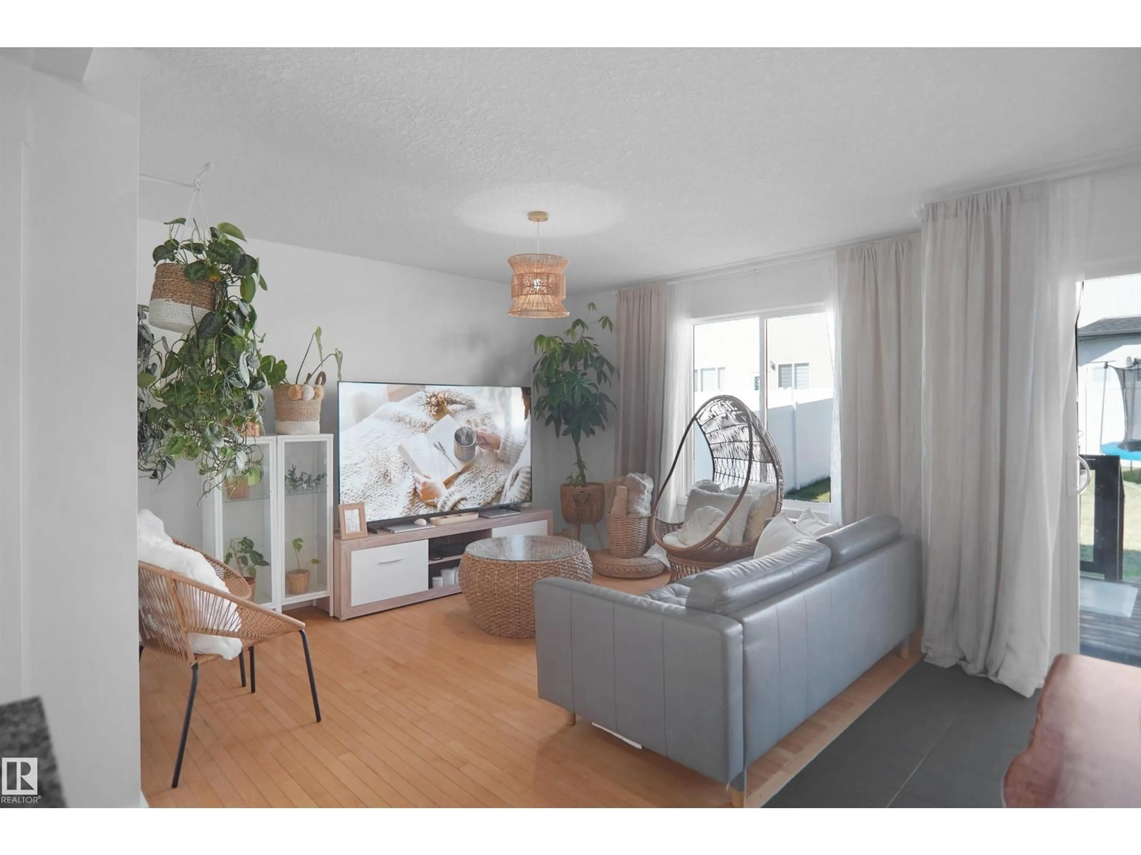 Living room with furniture, wood/laminate floor for 16804 53 ST, Edmonton Alberta T5Y0R6