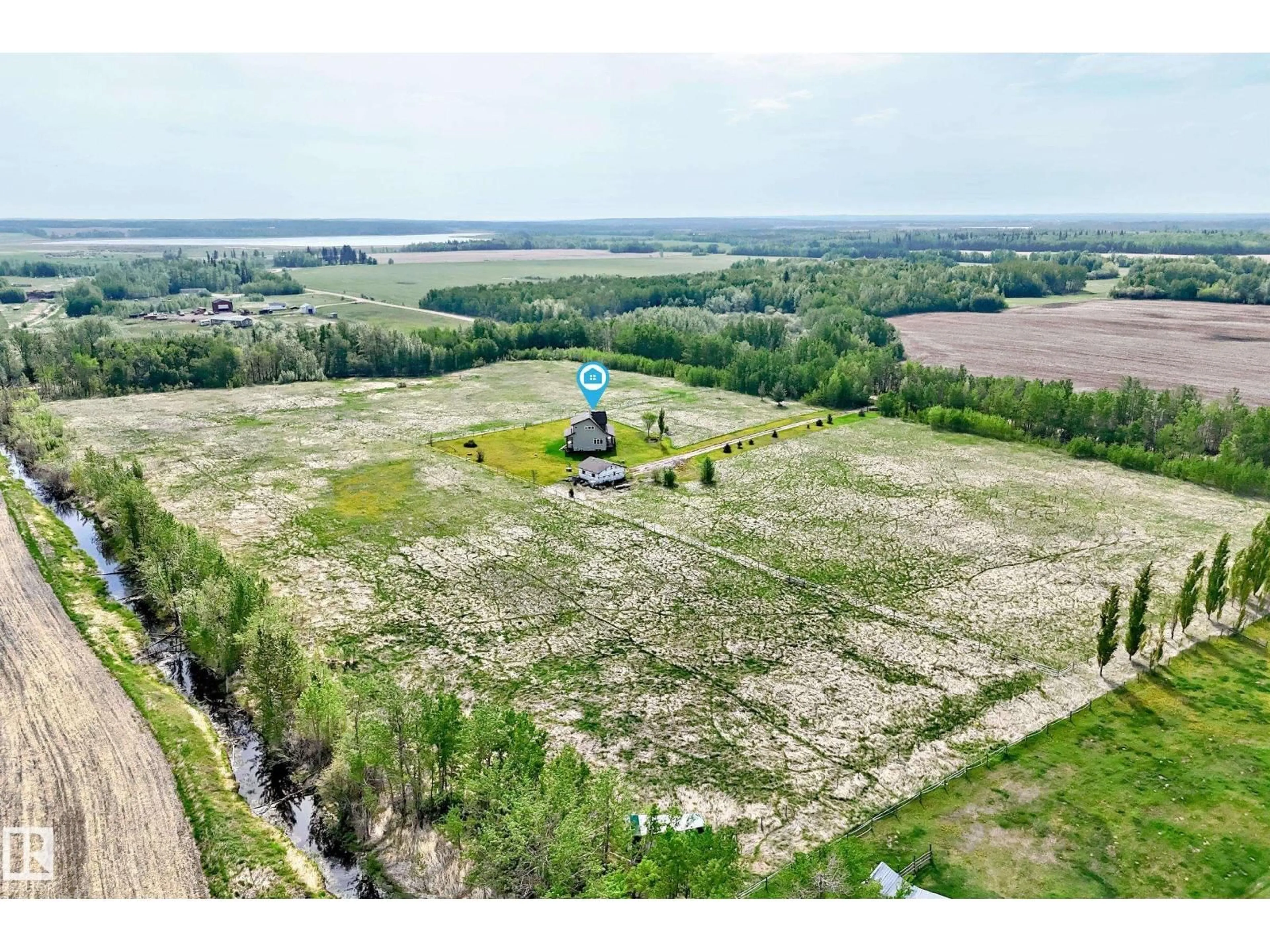 A pic from outside/outdoor area/front of a property/back of a property/a pic from drone, water/lake/river/ocean view for 2420 TWP ROAD 555, Rural Lac Ste. Anne County Alberta T0E1J0