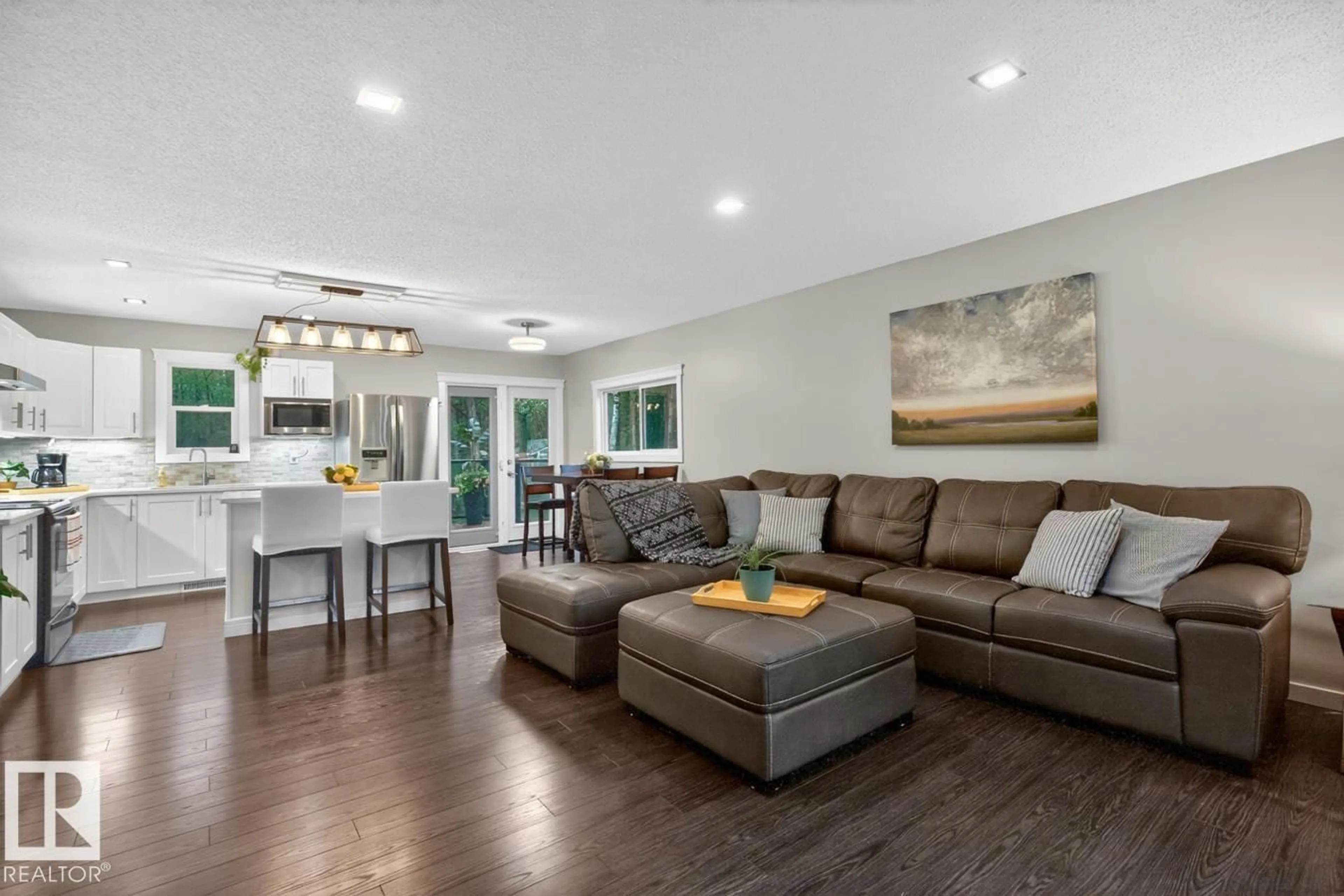 Living room with furniture, wood/laminate floor for 51520 - 13 RR 200A RR, Rural Beaver County Alberta T0B4J1