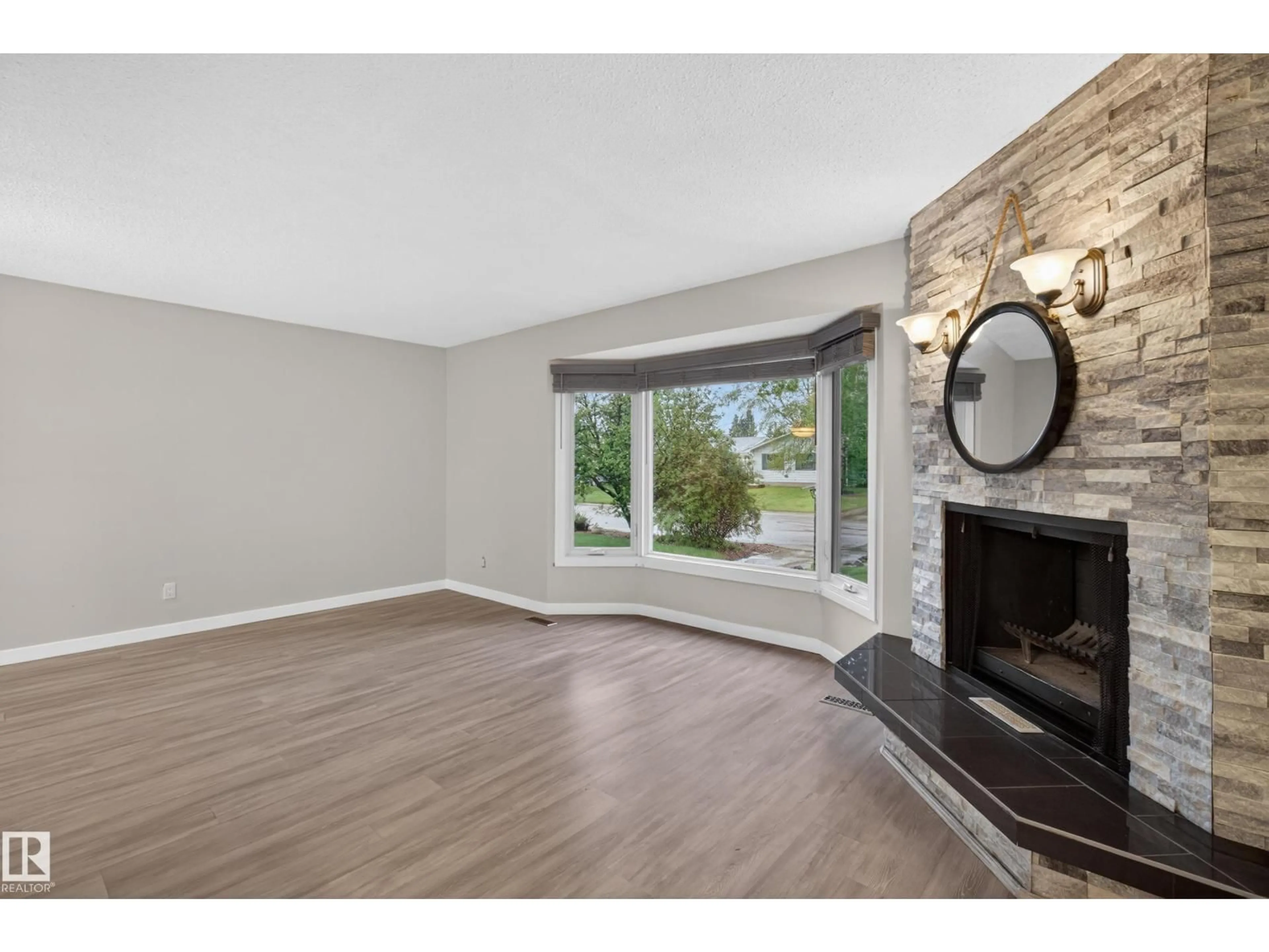Living room with furniture, wood/laminate floor for 302 FIR ST, Sherwood Park Alberta T8A2B3